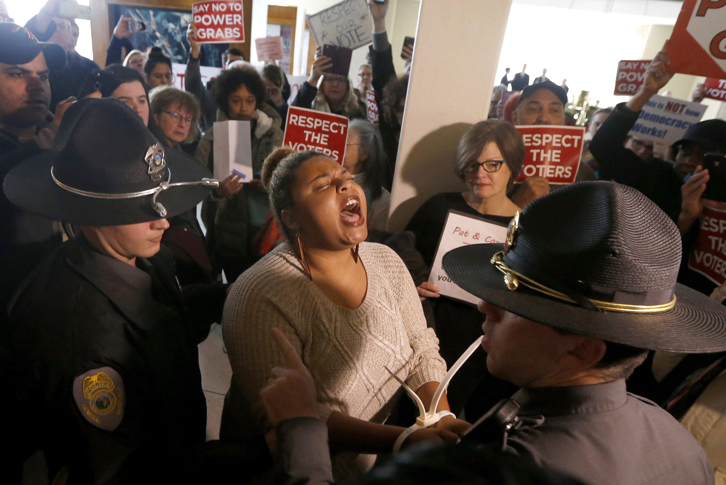 A protestor shouts as she is arrested outside the House gallery during a special session of the North Carolina General Assembly, Dec. 16, 2016 at the Legislative Building in Raleigh, N.C. (Ethan Hyman—Raleigh News &amp; Observer/TNS/Getty Images)