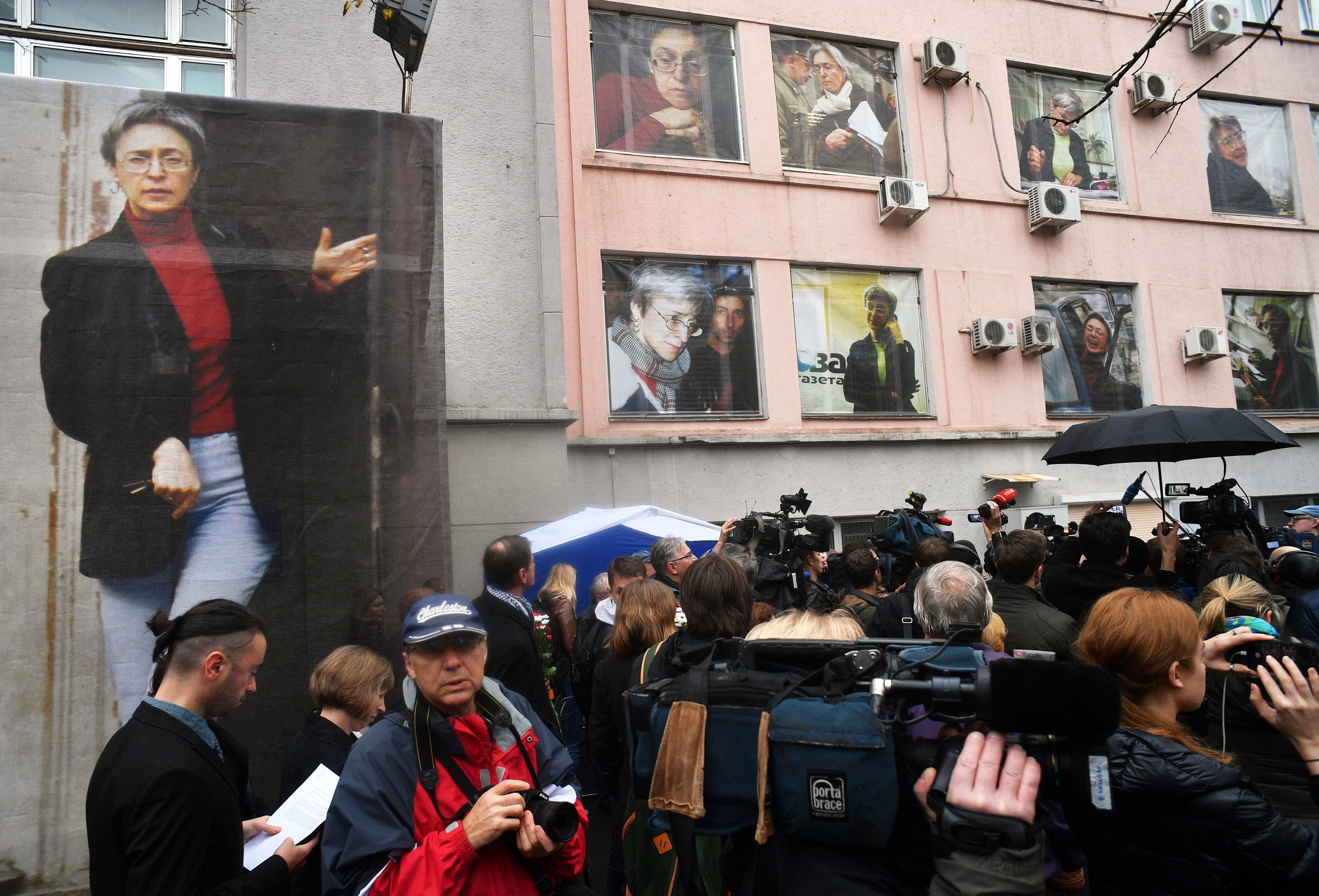 Ten giant portraits are posted on the windows of the <i>Novaya Gazeta</i> editorial office during a commemorative event on Oct. 7, 2016, marking the 10th anniversary of journalist Anna Politkovskaya's death (Maksim Blinov—Sputnik/AP)