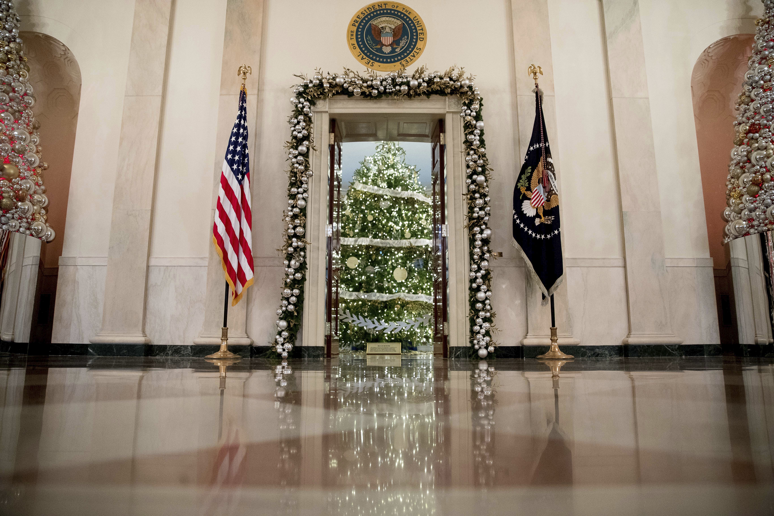 This year's White House Christmas Tree is seen inside the Blue Room from the Cross Hall of the White House during a preview of the 2016 holiday decor at the White House, on Nov. 29, 2016. (Andrew Harnik—AP)