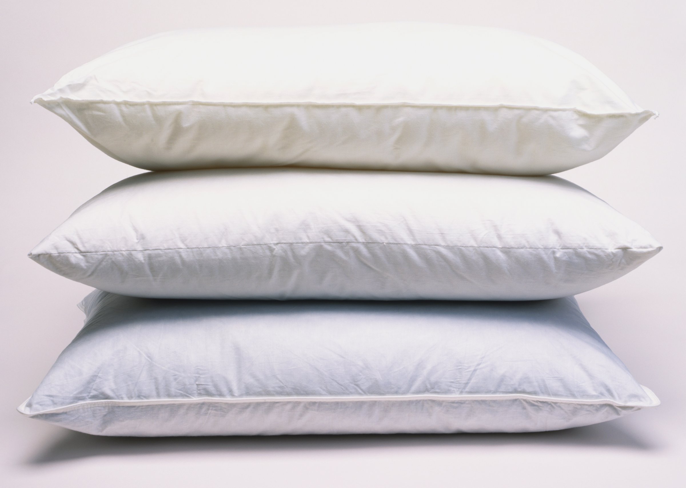 Three stacked white pillows, side view