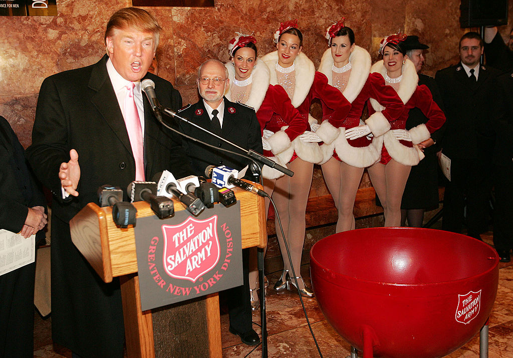 The Radio City Rockettes listen as Donald Trump speaks during a ceremony to help The Salvation Army kick off its annual Christmas kettle effort at the Trump Tower Atrium on Nov. 23, 2004 in New York City. (Scott Gries&mdash;Getty Images)
