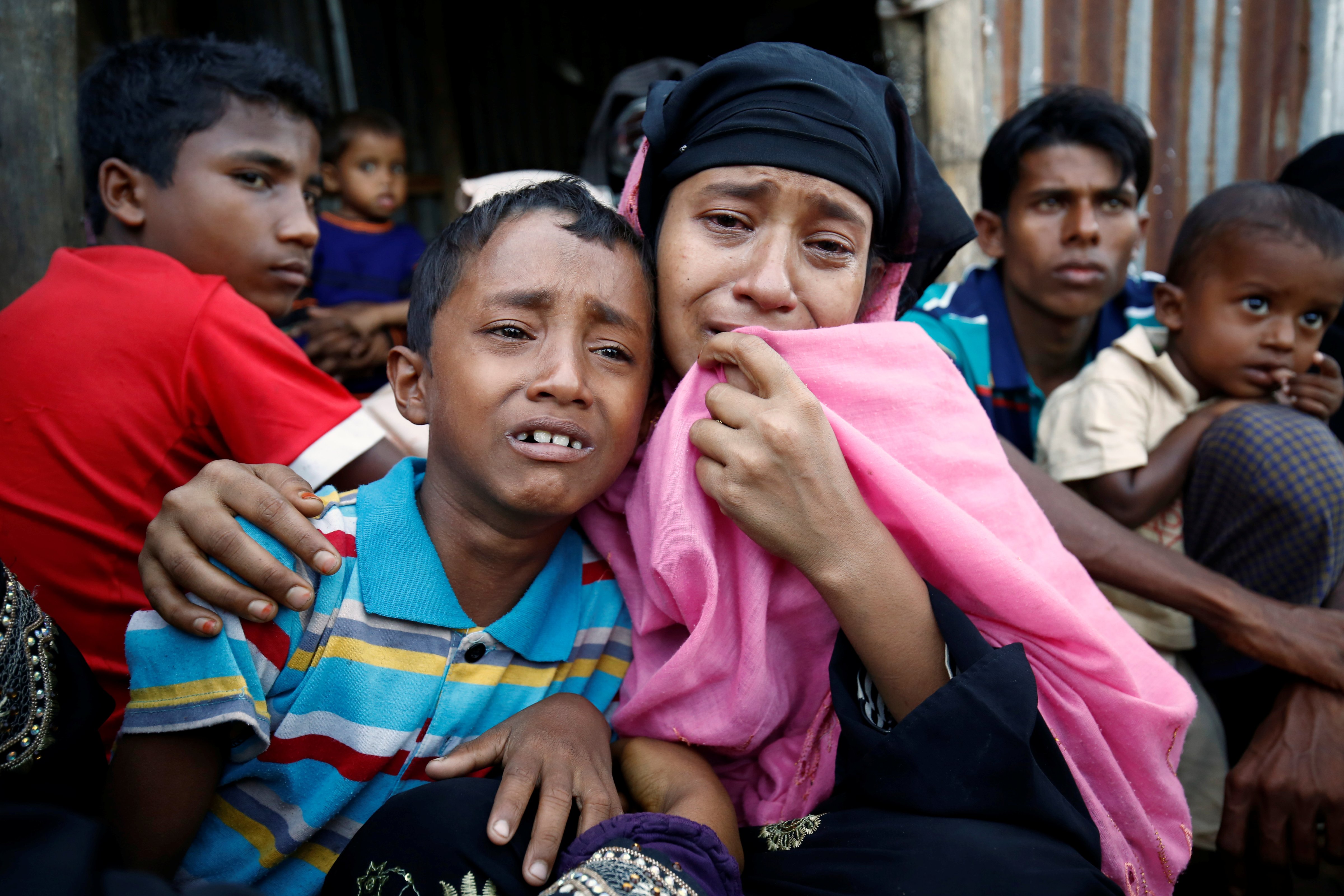 A Rohingya Muslim woman and her son cry after being caught by Border Guard Bangladesh (BGB) while illegally crossing at a border check point in Cox's Bazar, Bangladesh, on Nov. 21, 2016 (Mohammad Ponir Hossain—REUTERS)
