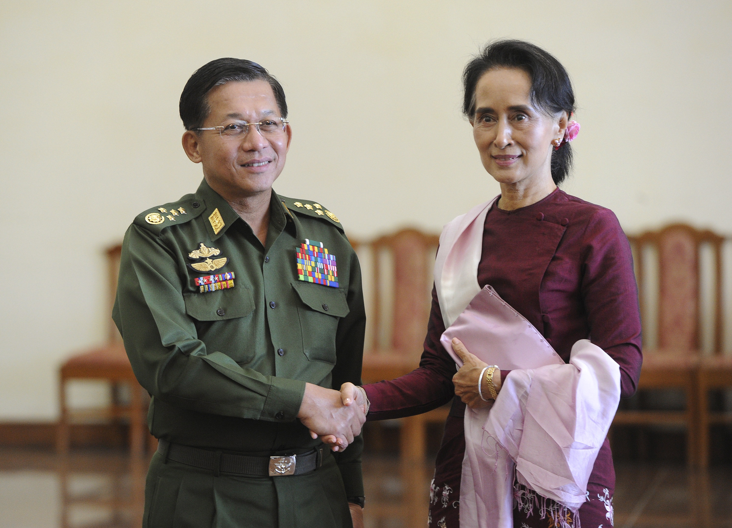 Myanmar's Commander-in-Chief Min Aung Hlaing and National League for Democracy (NLD) party leader Aung San Suu Kyi shake hands after their meeting in Naypyitaw