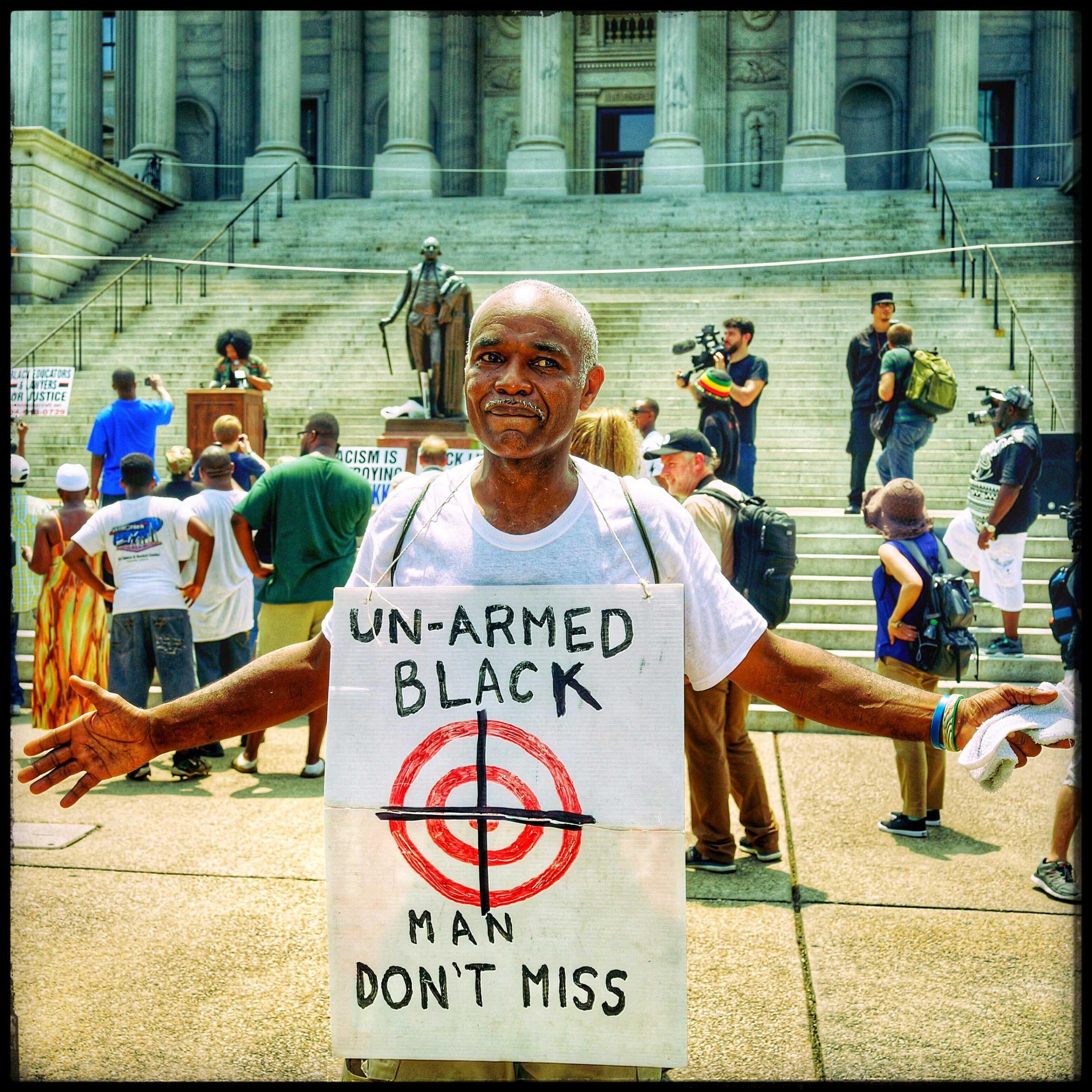 This man armed only with a sign around his neck demonstrates in front of the Capital Building in South Carolina. The event  was the staging of both a Ku Klux Klan and a Black Panther rally, both scheduled in the same area.