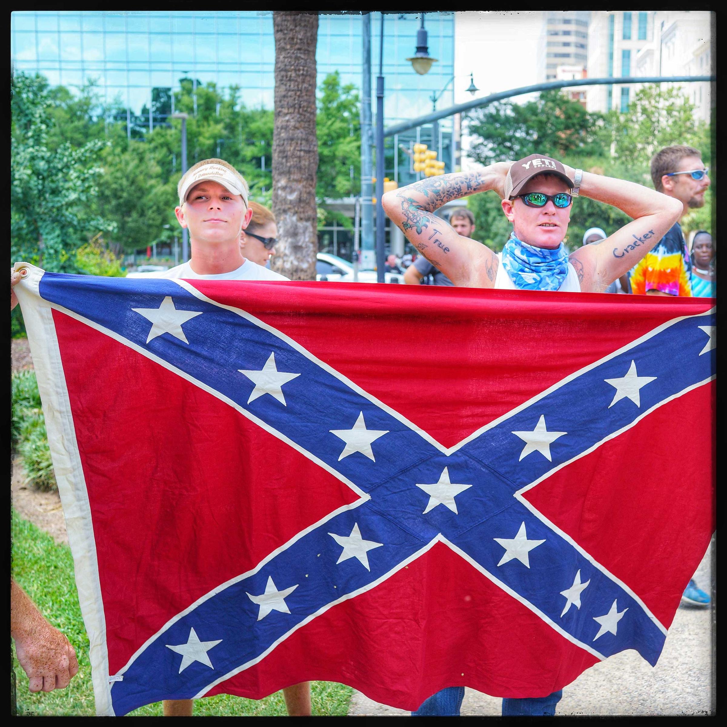 Young boys supporting the Ku Klux Klan stand in solidarity with the group outside of the South Carolina Capitol bulding to protest the taking down of the conferderate flag from the federal buildings in that state.