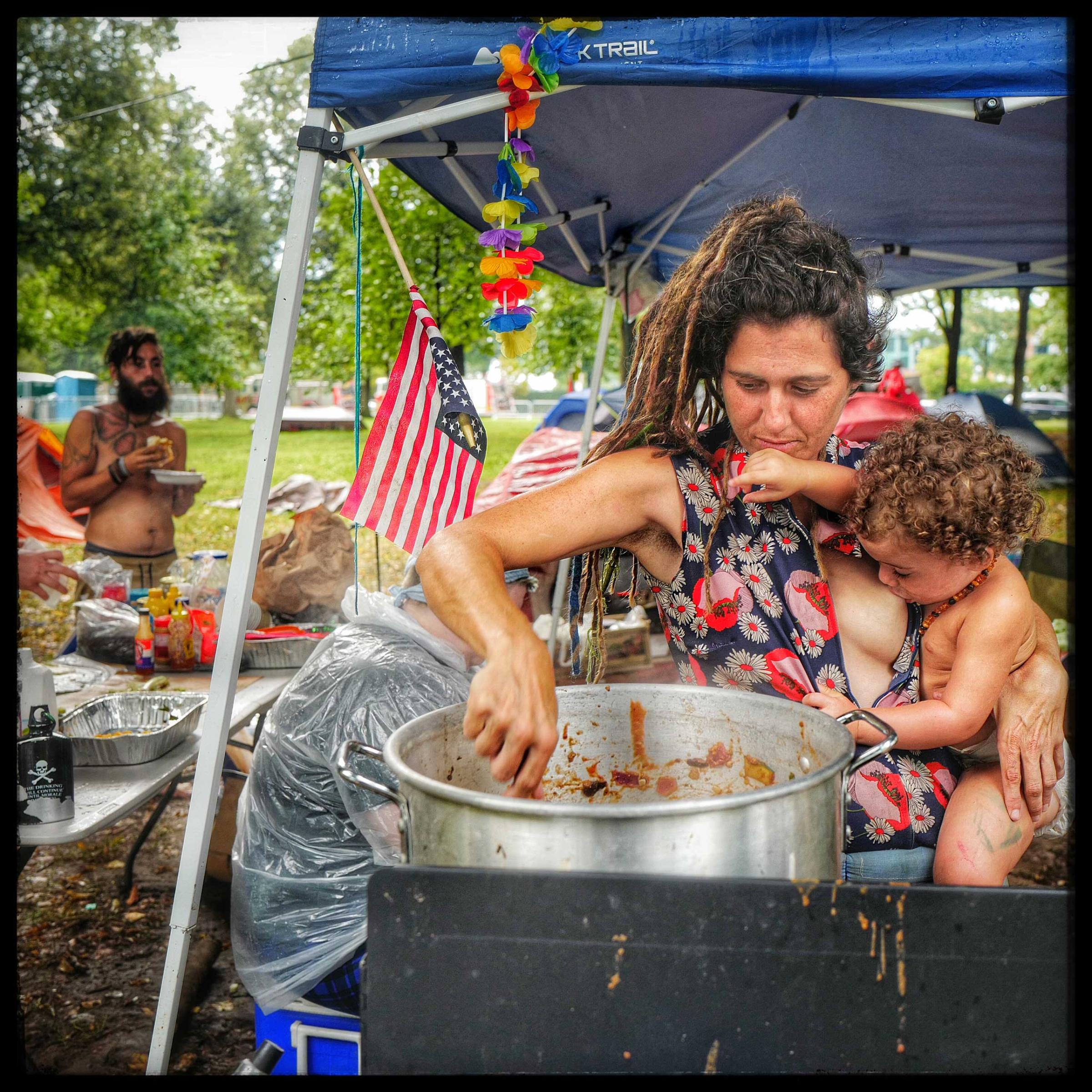 Stacey and her daughter Joy prepare a pot of zucchini, tomatoes and squash for protestors at the Democratic National Convention that was held in Philadelphia.