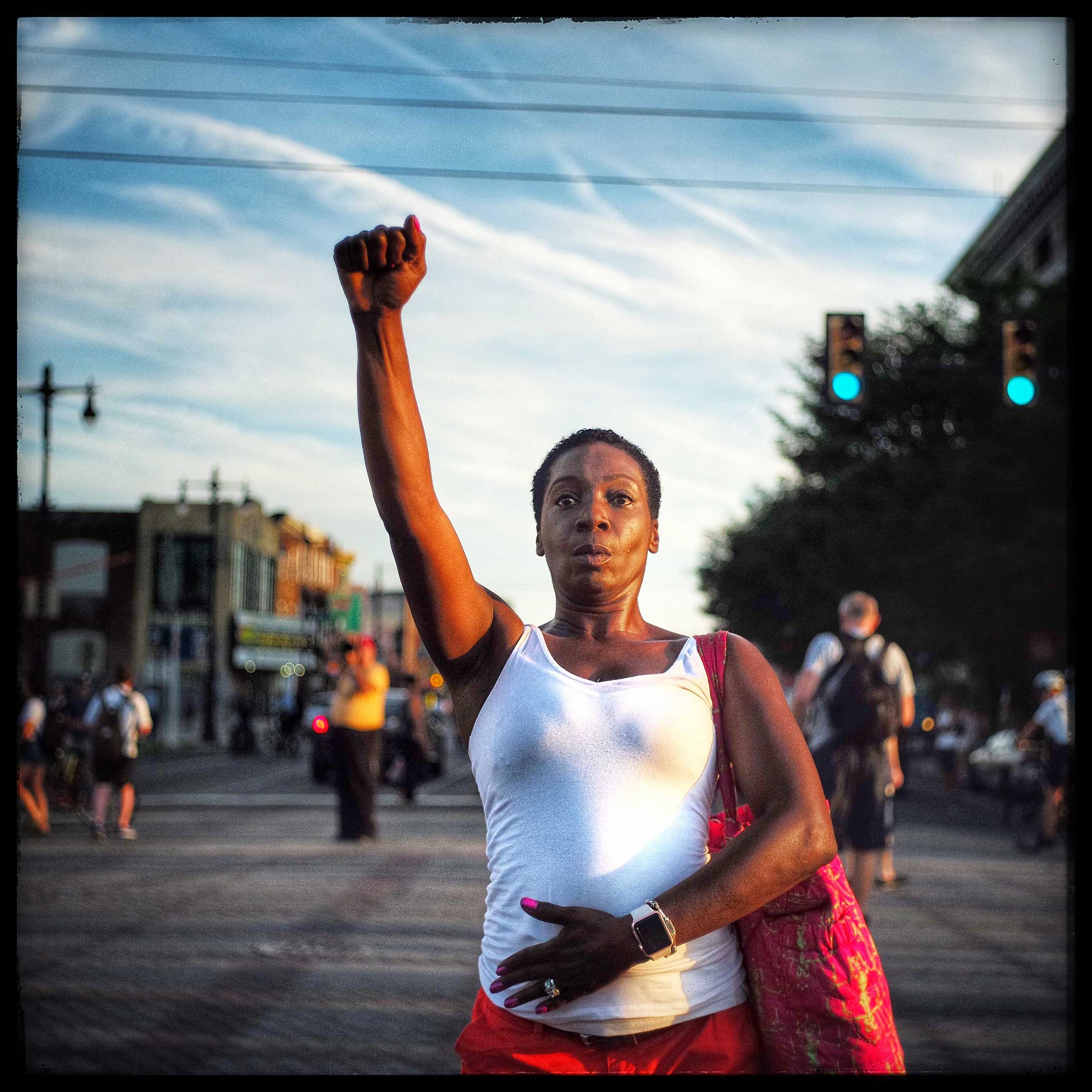 A lone protestor pauses to stop and salute other protestors on their way to the Democratic National Convention which was held in Philadelphia, Pennsylvania.