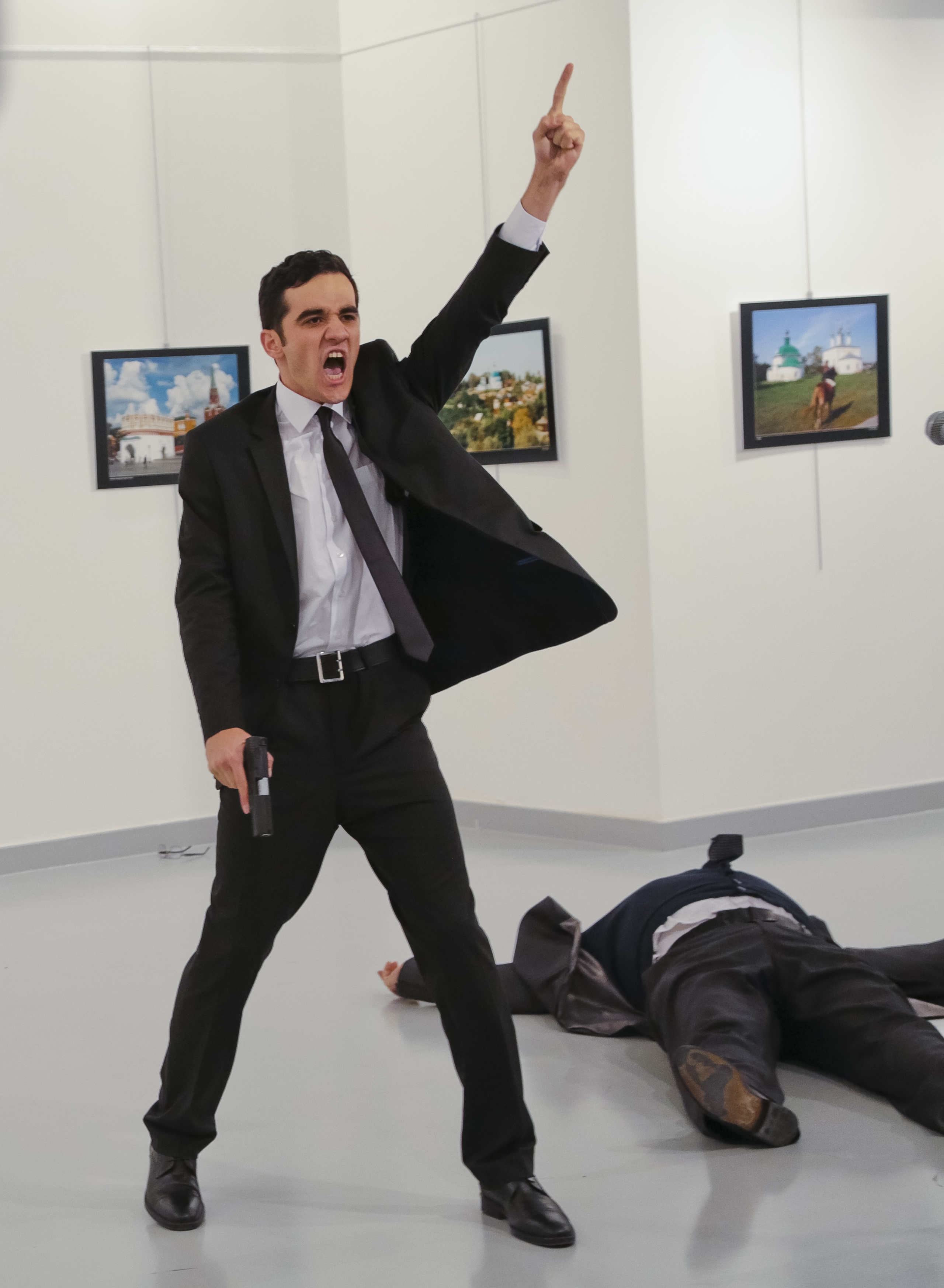 The gunman gestures after shooting the Russian Ambassador to Turkey, Andrey Karlov, at a photo exhibition in Ankara on Dec. 19, 2016. (Burhan Ozbilici—AP)