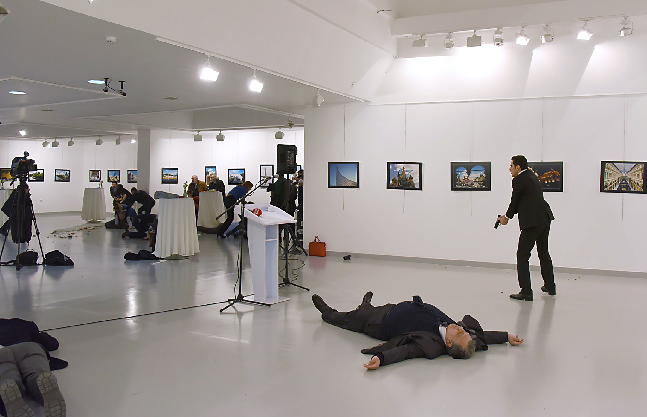 Andrey Karlov, Russia's ambassador to Turkey, lays on the ground after being shot by a gunman at a photo exhibit in Ankara on Dec. 19. He later died from his wounds. (Yavuz Alatan—AFP/Getty Images)