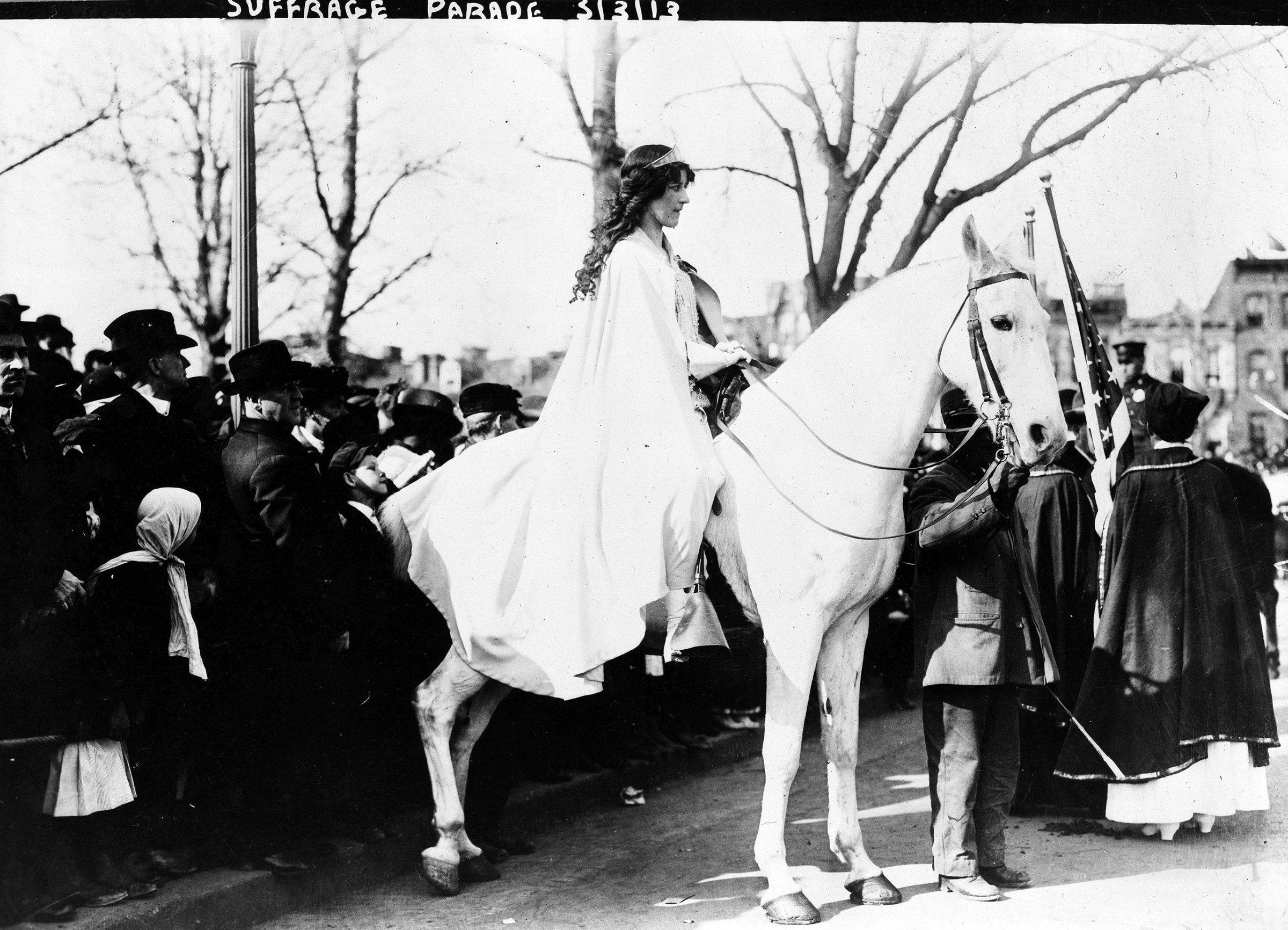 Inez Milholland Boissevain, wearing white cape, seated on white horse at the National American Woman Suffrage Association parade, March 3, 1913, Washington, D.C.