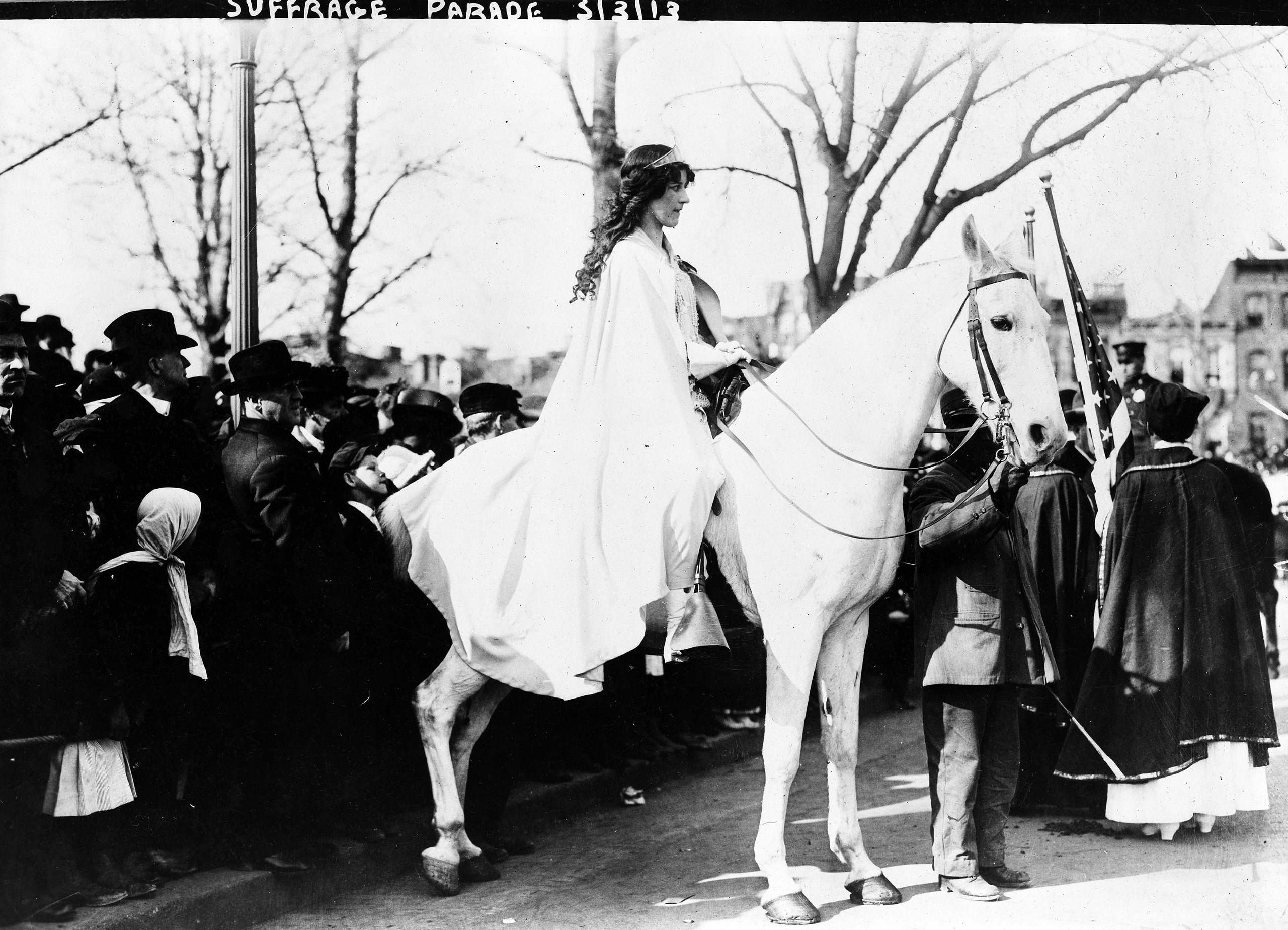 Inez Milholland Boissevain, wearing white cape, seated on white horse at the National American Woman Suffrage Association parade, March 3, 1913, Washington, D.C. (Library of Congress)