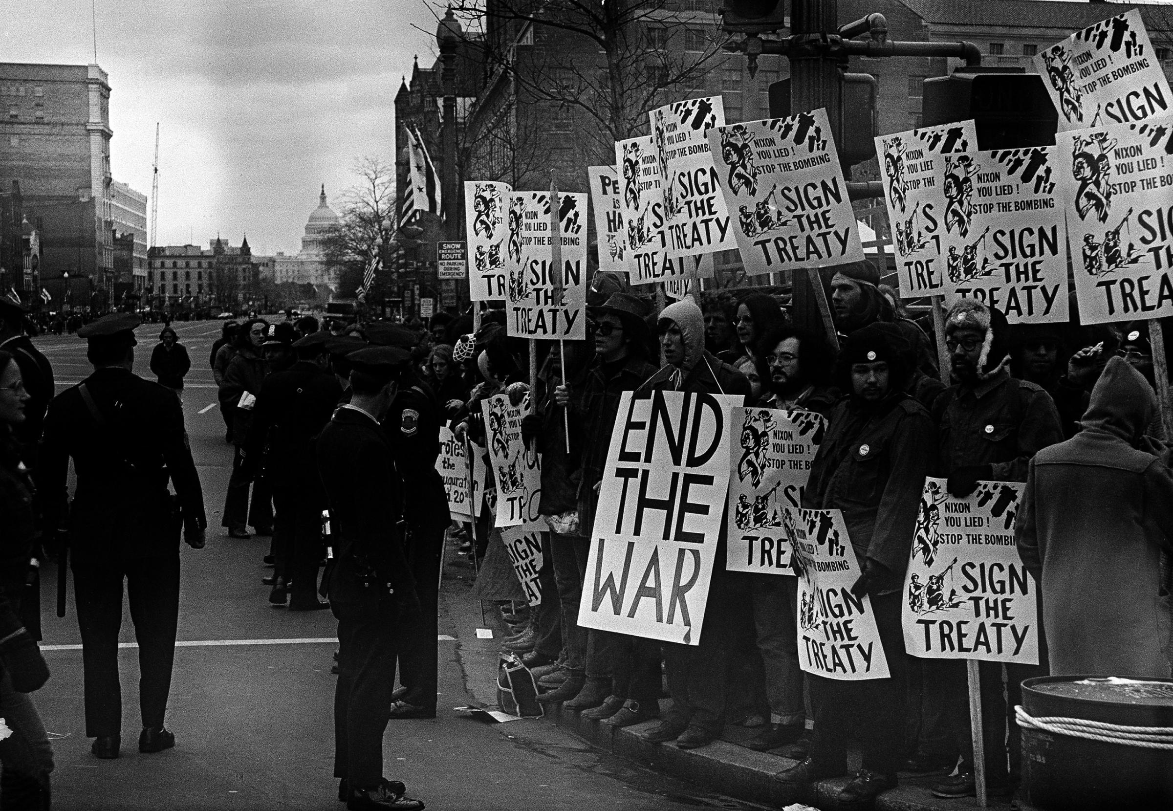 Police stand in front of group of antiwar demonstrators lined along Pennsylvania Avenue in Washington, D.C., Jan. 20, 1973, before the inauguration pf President Richard M. Nixon.