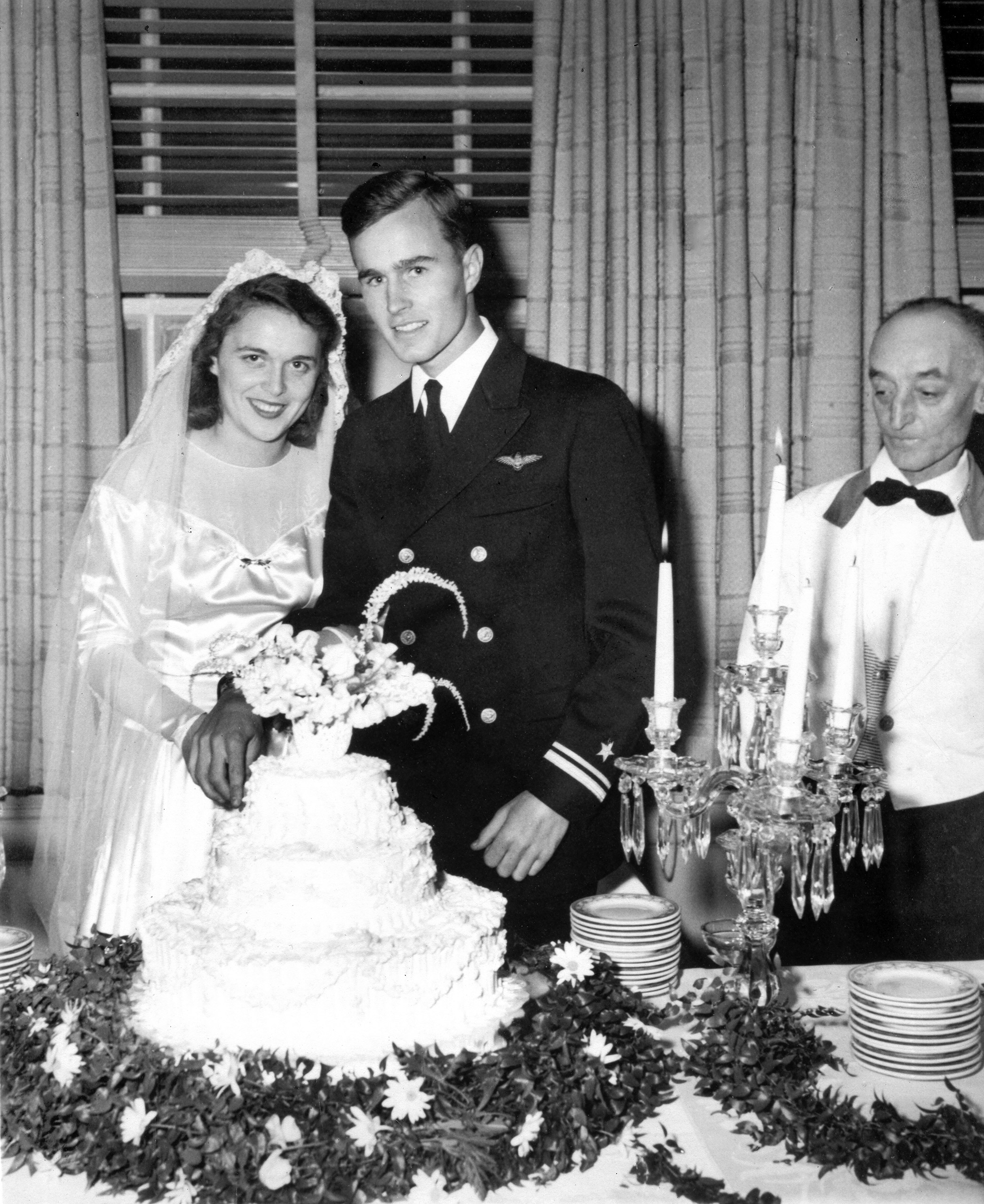 George and Barbara Bush cut their wedding cake, Rye, New York on Jan. 6, 1945.