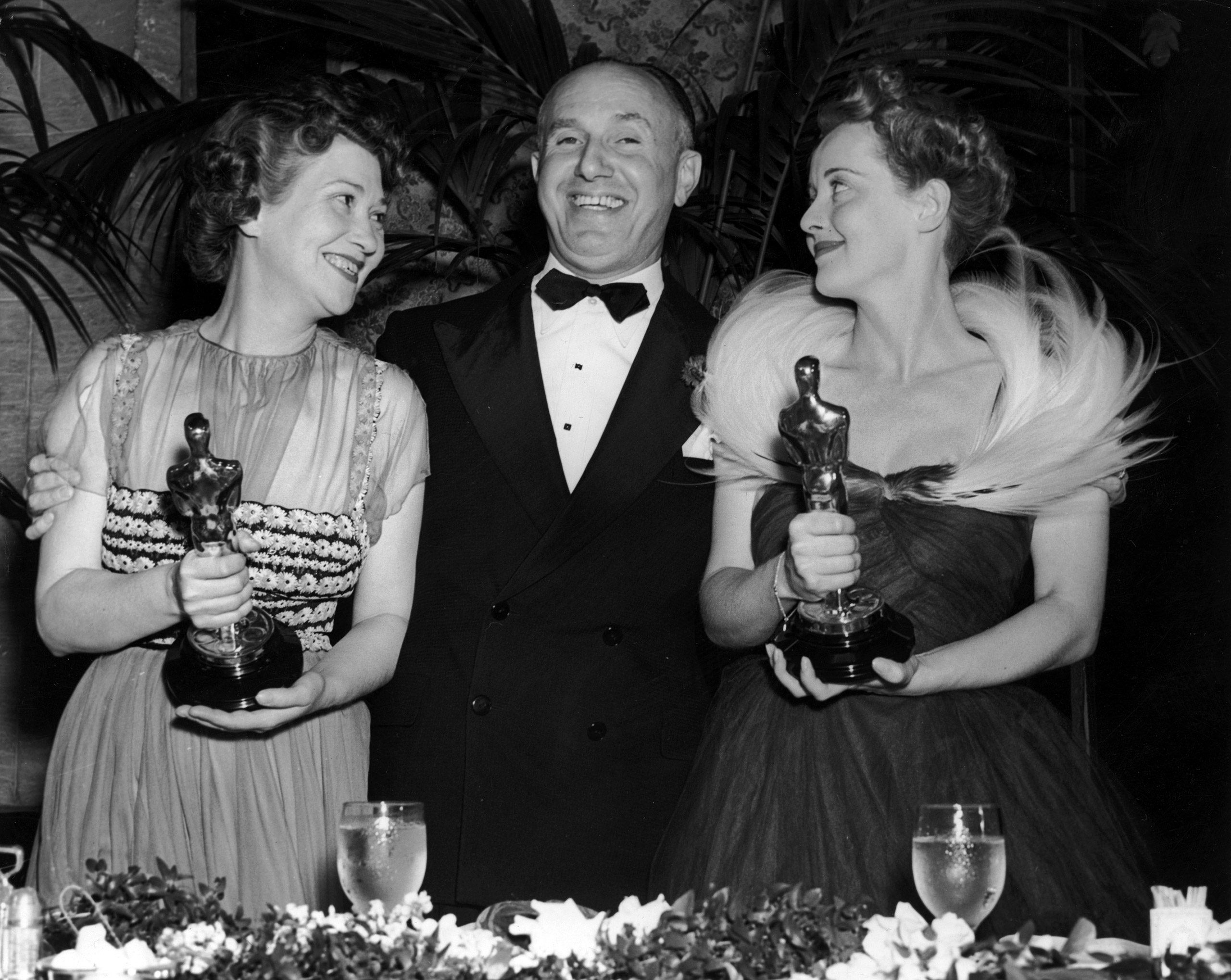 Jack Warner with Fay Bainter and Bette Davis who hold their Oscars at the Academy Awards, 1939.