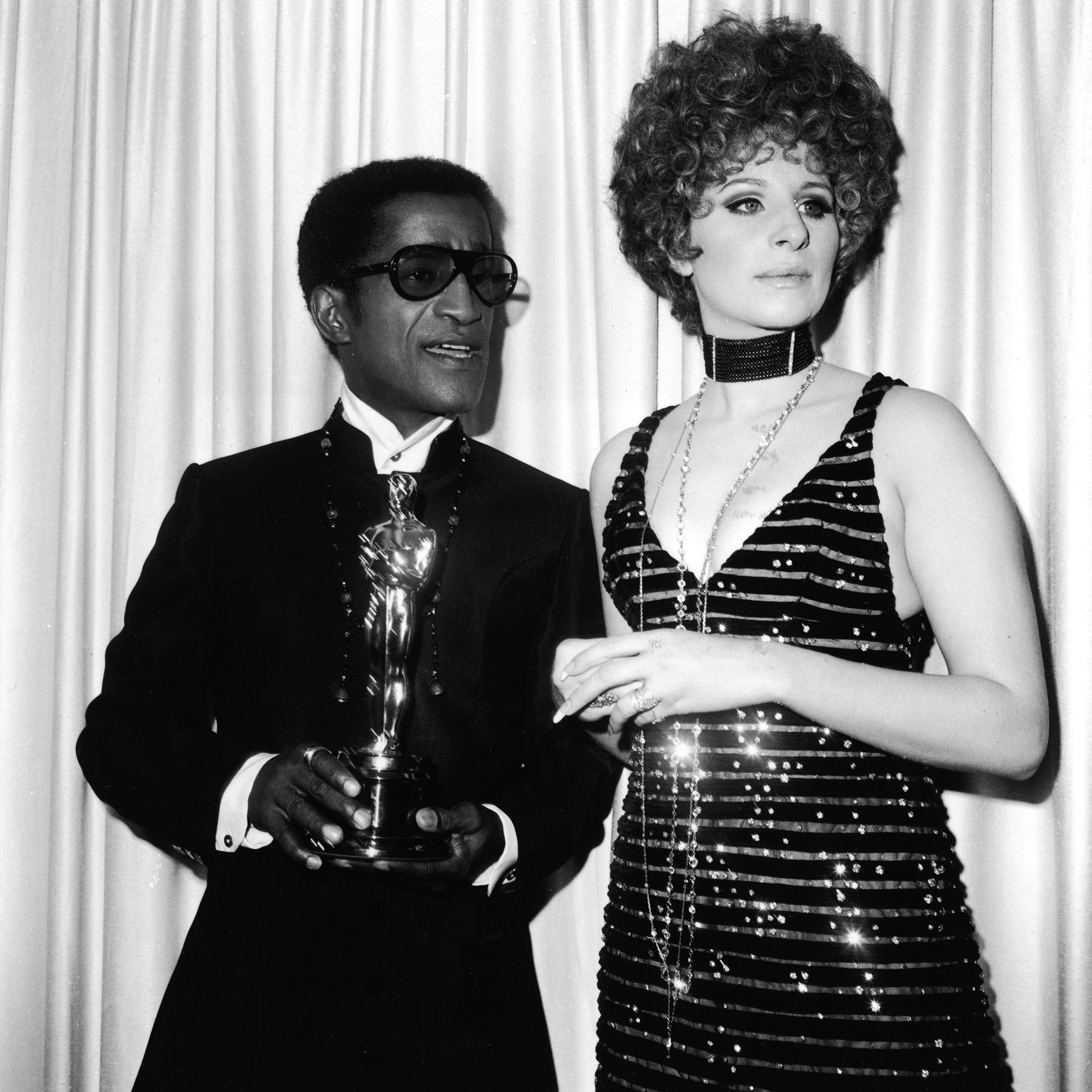 Sammy Davis Jr. with Barbra Streisand, holding the Oscar for Best Song, at the Academy Awards, 1968.