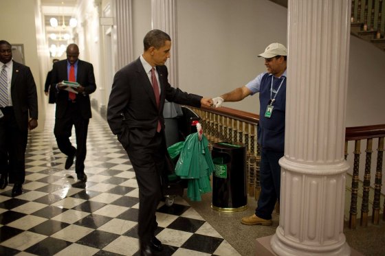President Barack Obama fist-bumps custodian Lawrence Lipscomb in the Eisenhower Executive Office Building following the opening session of the White House Forum on Jobs and Economic Growth, Dec. 3, 2009. (Official White House Photo by Pete Souza)This official White House photograph is being made available only for publication by news organizations and/or for personal use printing by the subject(s) of the photograph. The photograph may not be manipulated in any way and may not be used in commercial or political materials, advertisements, emails, products, promotions that in any way suggests approval or endorsement of the President, the First Family, or the White House.