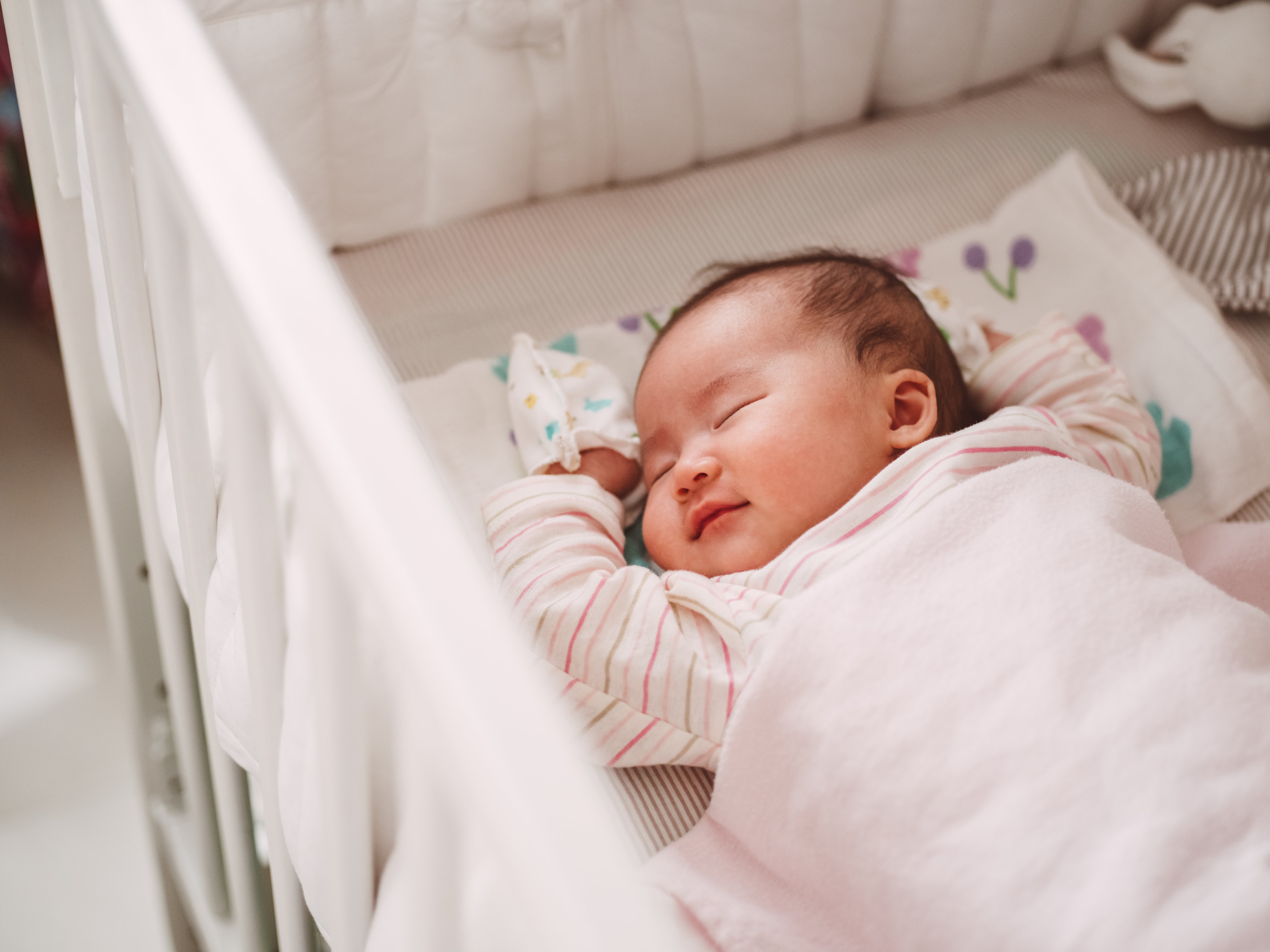 New born baby sleeping soundly in crib