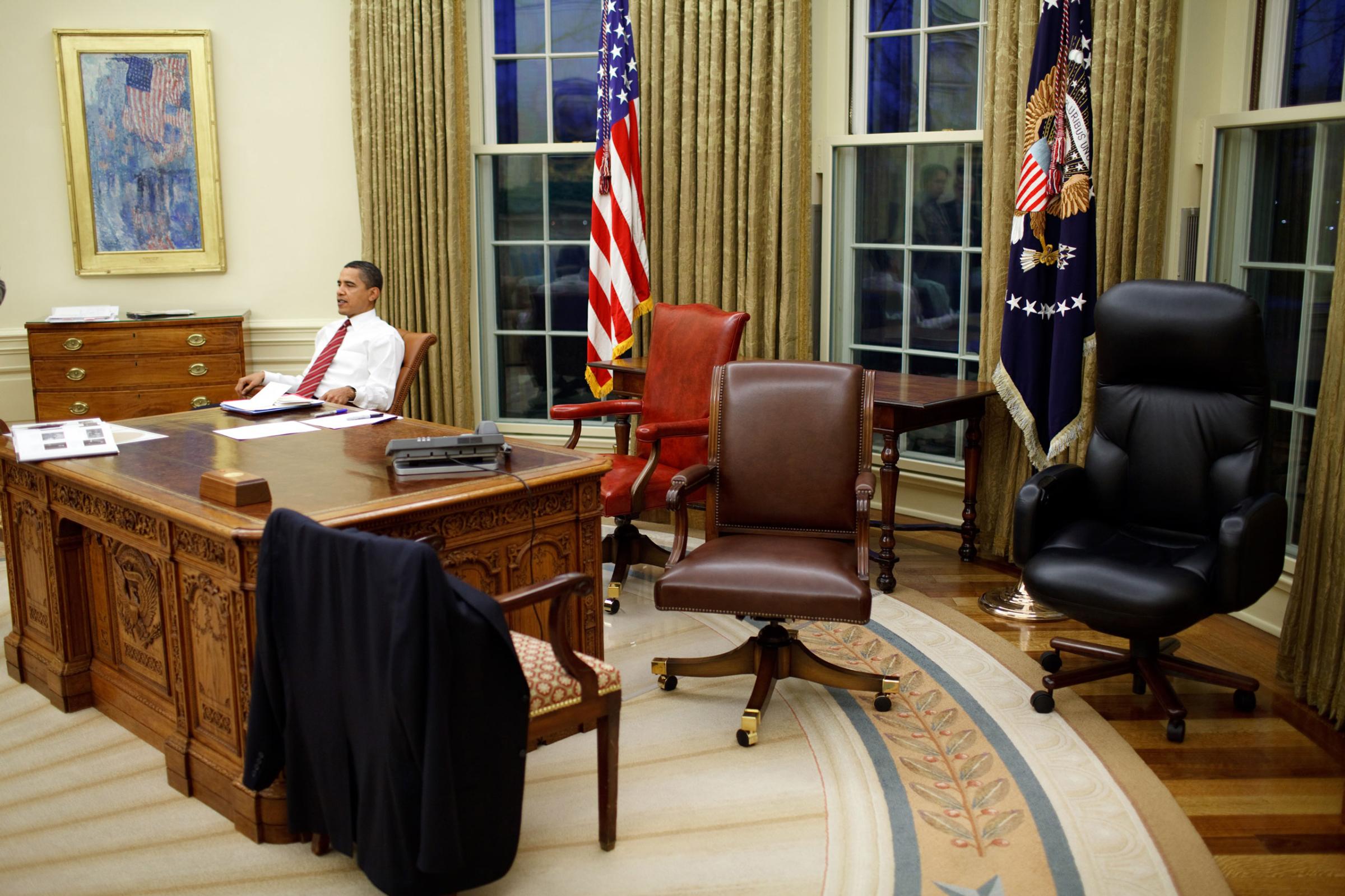 President Barack Obama tries out different desk chairs in the Oval Office, Jan. 30, 2009.