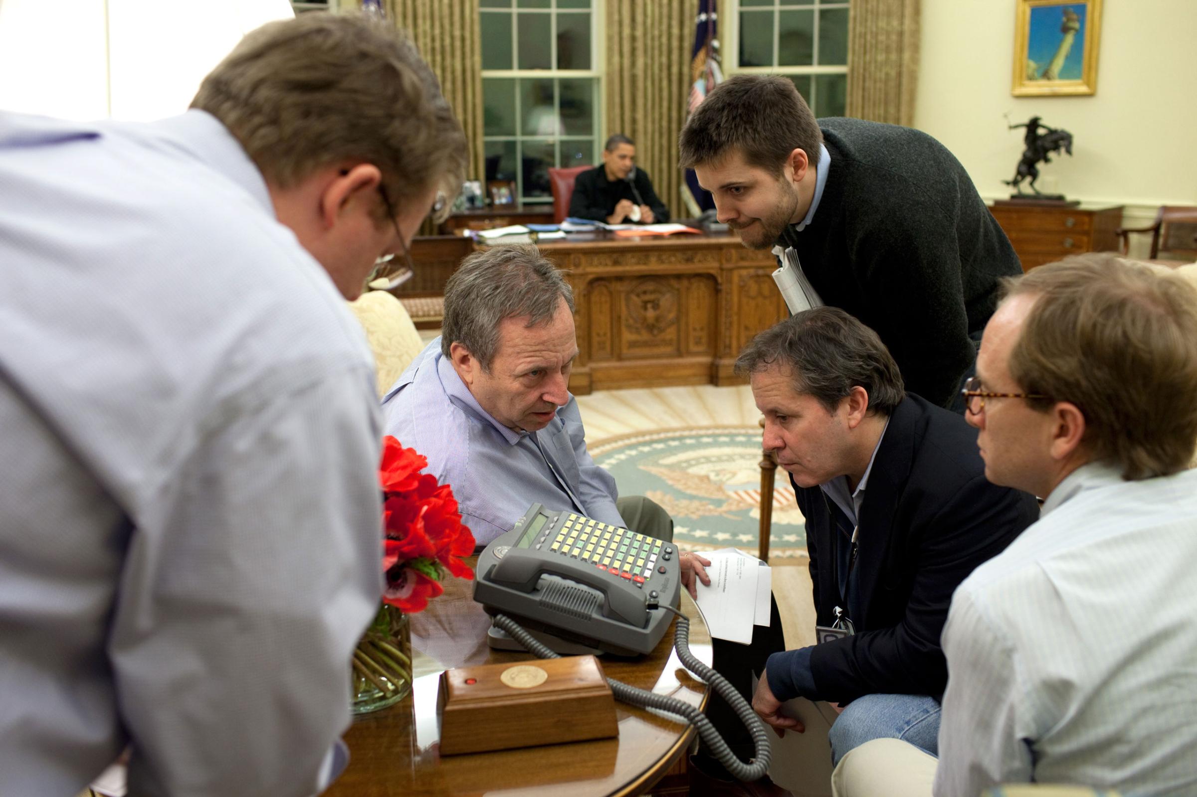 On Sunday night, March 29, 2009, aides listen to a speaker phone as the President made calls to alert officials about his plan to set deadlines for General Motors and Chrysler overhauls that were to be announced the next day.