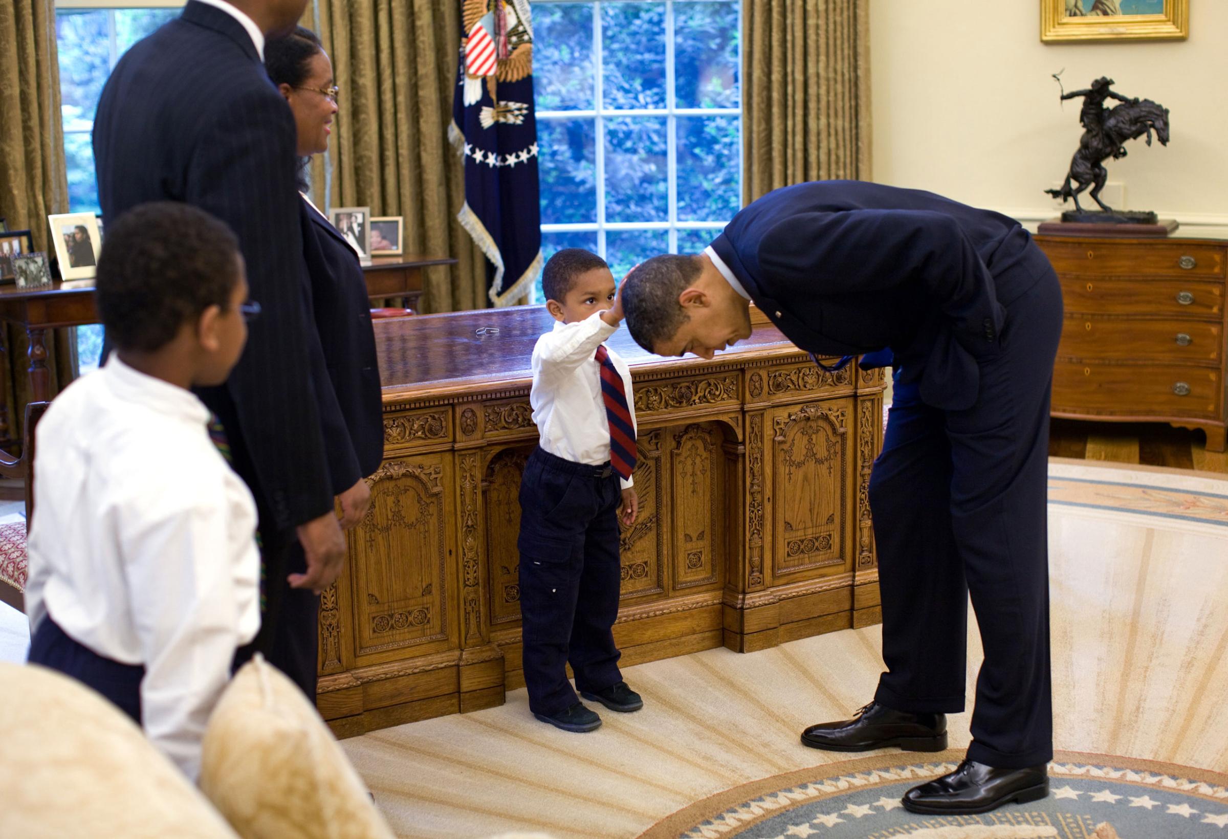 “A National Security staffer, Carlton Philadelphia, brought his family to the Oval Office for a farewell photo with President Obama. Carlton’s son, Jacob, softly told the President he had just gotten a haircut like President Obama, and asked if he could feel the President’s head to see if it felt the same as his.”