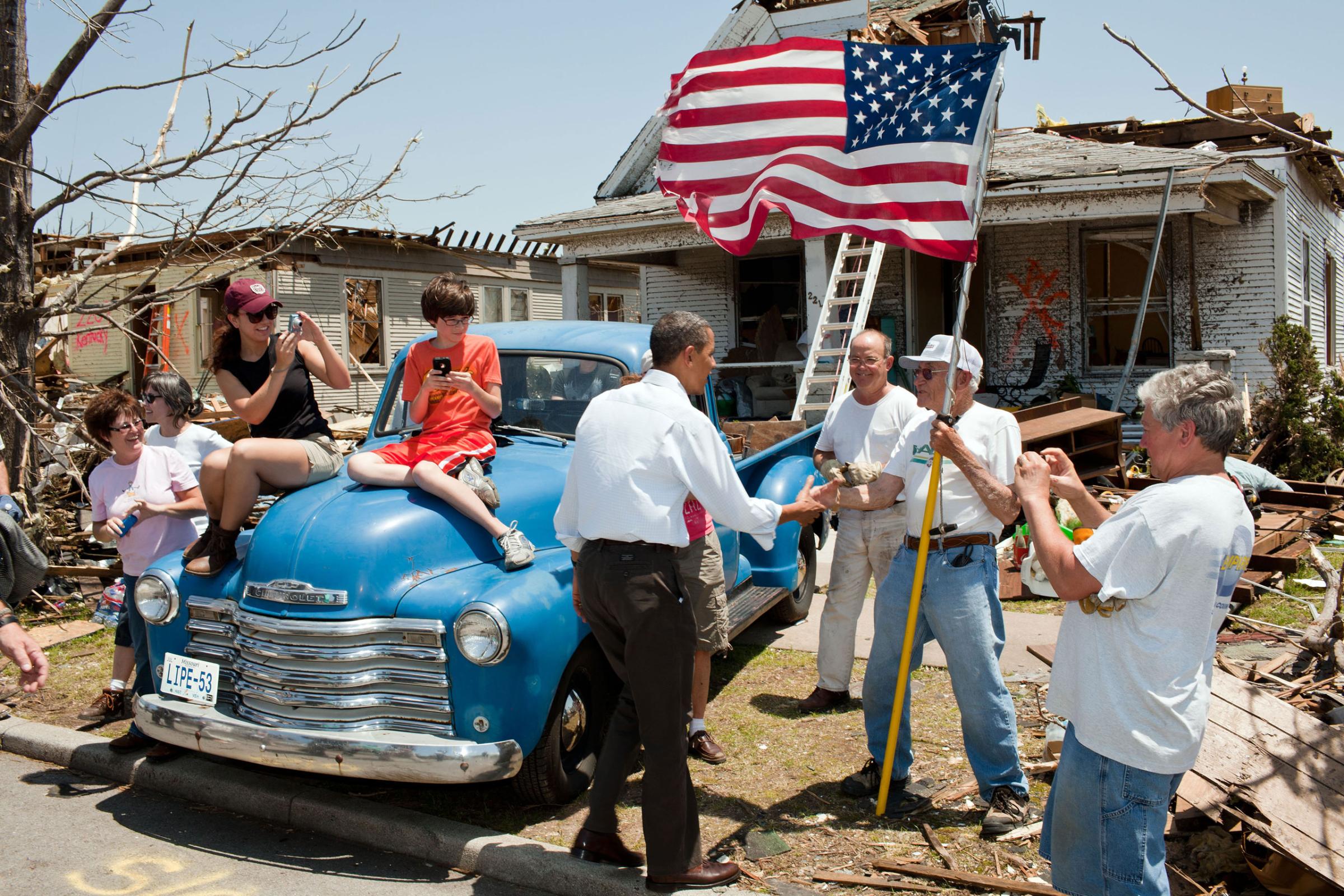 The President visits Joplin, Mo., on May 29, 2011, following a devastating tornado. Here he greets Hugh Hills, 85, in front of his home. Hills told the President he hid in a closet during the tornado, which destroyed the second floor and half the first floor of his house.