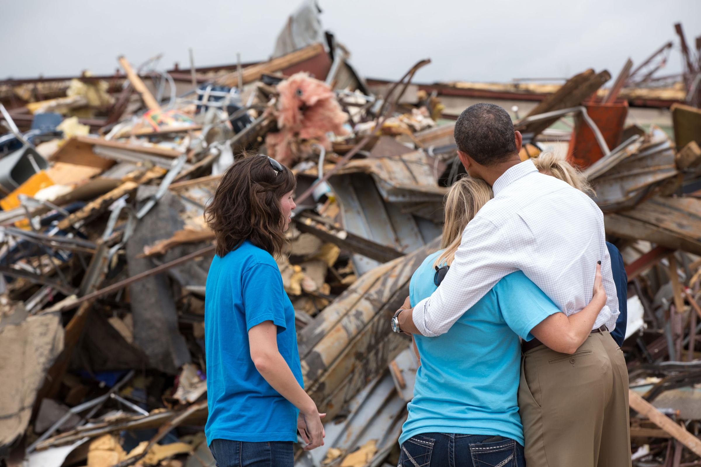 President Barack Obama hugs Amy Simpson, principal of Plaza Towers Elementary School, outside what remains of the school following a tornado in Moore, Okla., May 26, 2013.