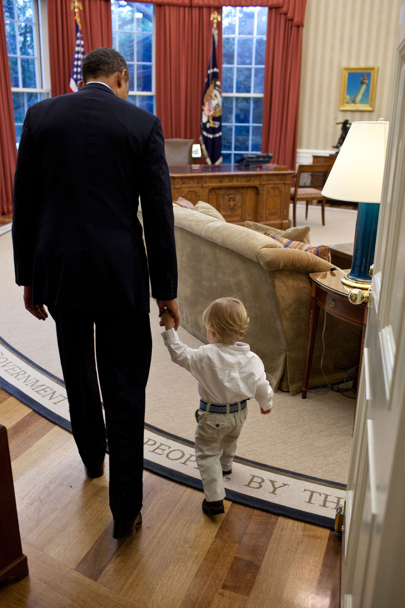 “When a White House staff member leaves their job, the President usually invites the staff member and his family to the Oval Office for a family photo to thank them for their service. Here the President walks with William Jones, son of departing aide Luke Jones, before a family photo,” Sept. 29, 2011.