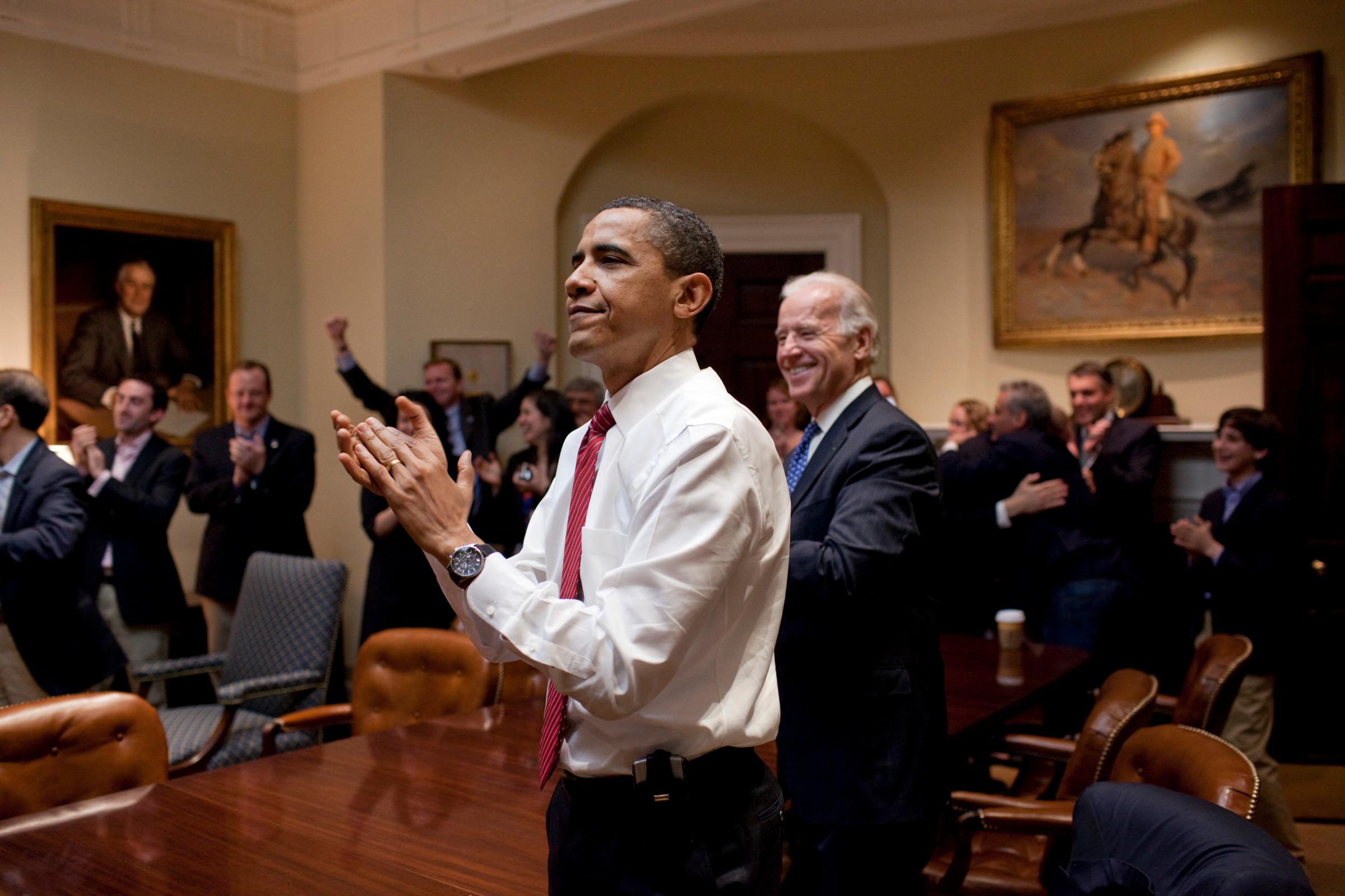 President Barack Obama, Vice President Joe Biden, and senior staff, react in the Roosevelt Room of the White House, as the House passes the health care reform bill, March 21, 2010. (Official White House Photo by Pete Souza)This official White House photograph is being made available only for publication by news organizations and/or for personal use printing by the subject(s) of the photograph. The photograph may not be manipulated in any way and may not be used in commercial or political materials, advertisements, emails, products, promotions that in any way suggests approval or endorsement of the President, the First Family, or the White House. This official White House photograph is being made available only for publication by news organizations and/or for personal use printing by the subject(s) of the photograph. The photograph may not be manipulated in any way and may not be used in commercial or political materials, advertisements, emails, products, promotions that in any way suggests approval or endorsement of the President, the First Family, or the White House.