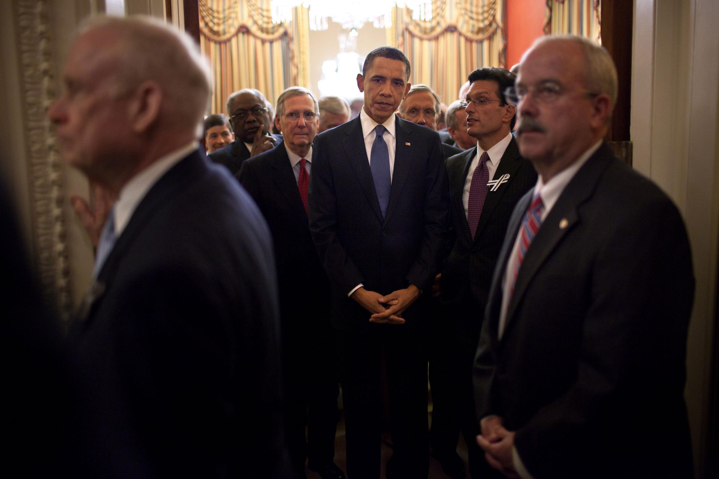 President Barack Obama stands with Members of Congress in House Speaker John Boehner's ceremonial office as Bill Livingood, House Sergeant at Arms, left, and Terrance Gainer, Senate Sergeant at Arms, right, prepare to escort them onto the floor of the House Chamber at the U.S. Capitol, Jan. 25, 2011.