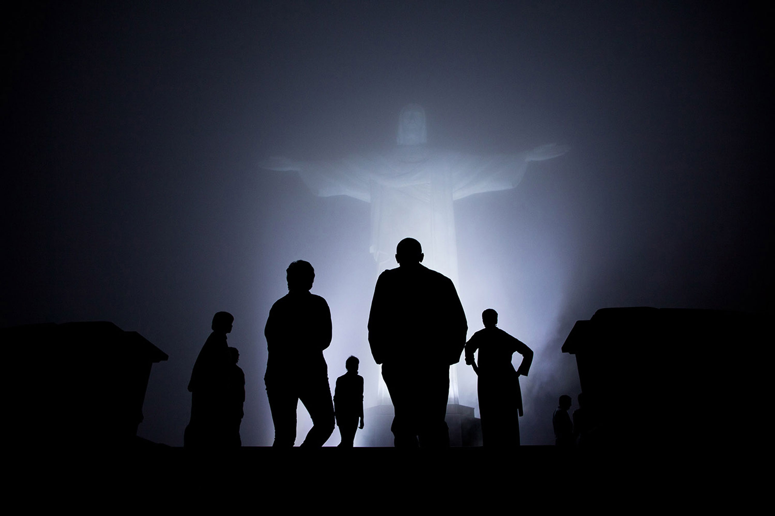The Obama family was scheduled to tour the Christ the Redeemer statue in Rio de Janeiro, Brazil, before dinner one night March 20, 2011. But when heavy fog rolled in, they decided to cancel the visit. After dinner though, the fog had dissipated somewhat so they decided to make the drive up the mountain after all. It was quite clear when they arrived and then the fog started to roll back in. I managed to capture this silhouette as they viewed the statute one last time just before departure.