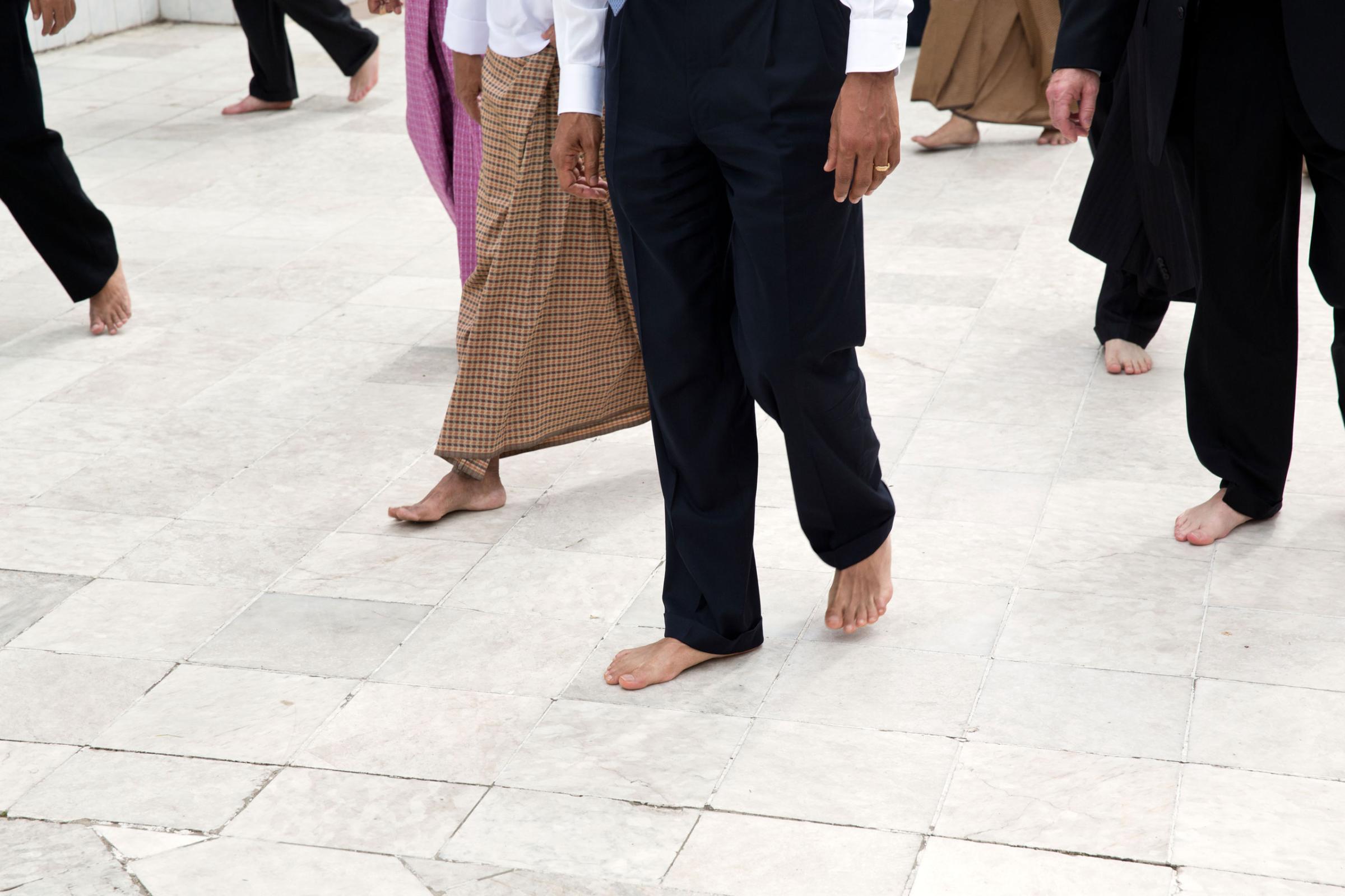 President Barack Obama, guides, and Secret Service agents walk barefoot during a tour of the Shwedagon Pagoda in Rangoon, Burma, Nov. 19, 2012.