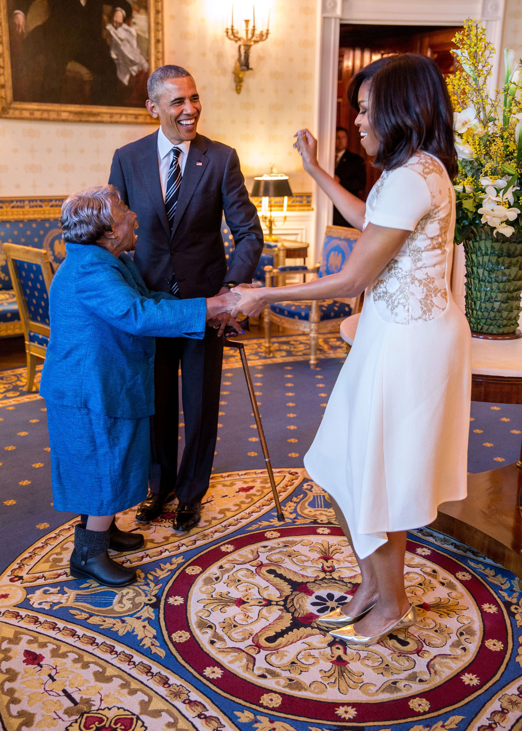 President Barack Obama watches First Lady Michelle Obama dance with 106-Year-Old Virginia McLaurin in the Blue Room of the White House prior to a reception celebrating African American History Month, Feb. 18, 2016.