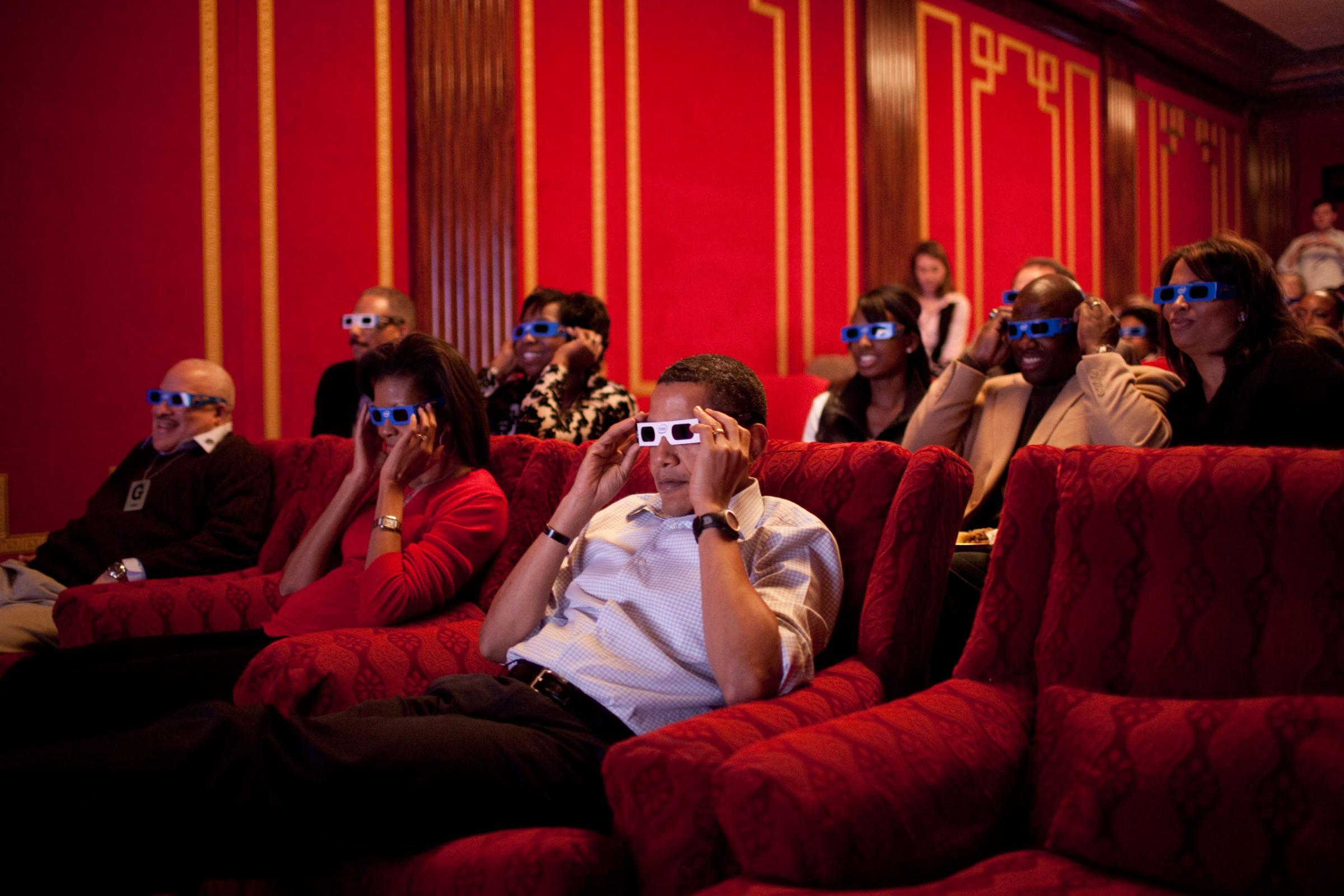 The President and First Lady, along with friends and family, watch a 3D commercial during the Super Bowl, Feb. 1, 2009.