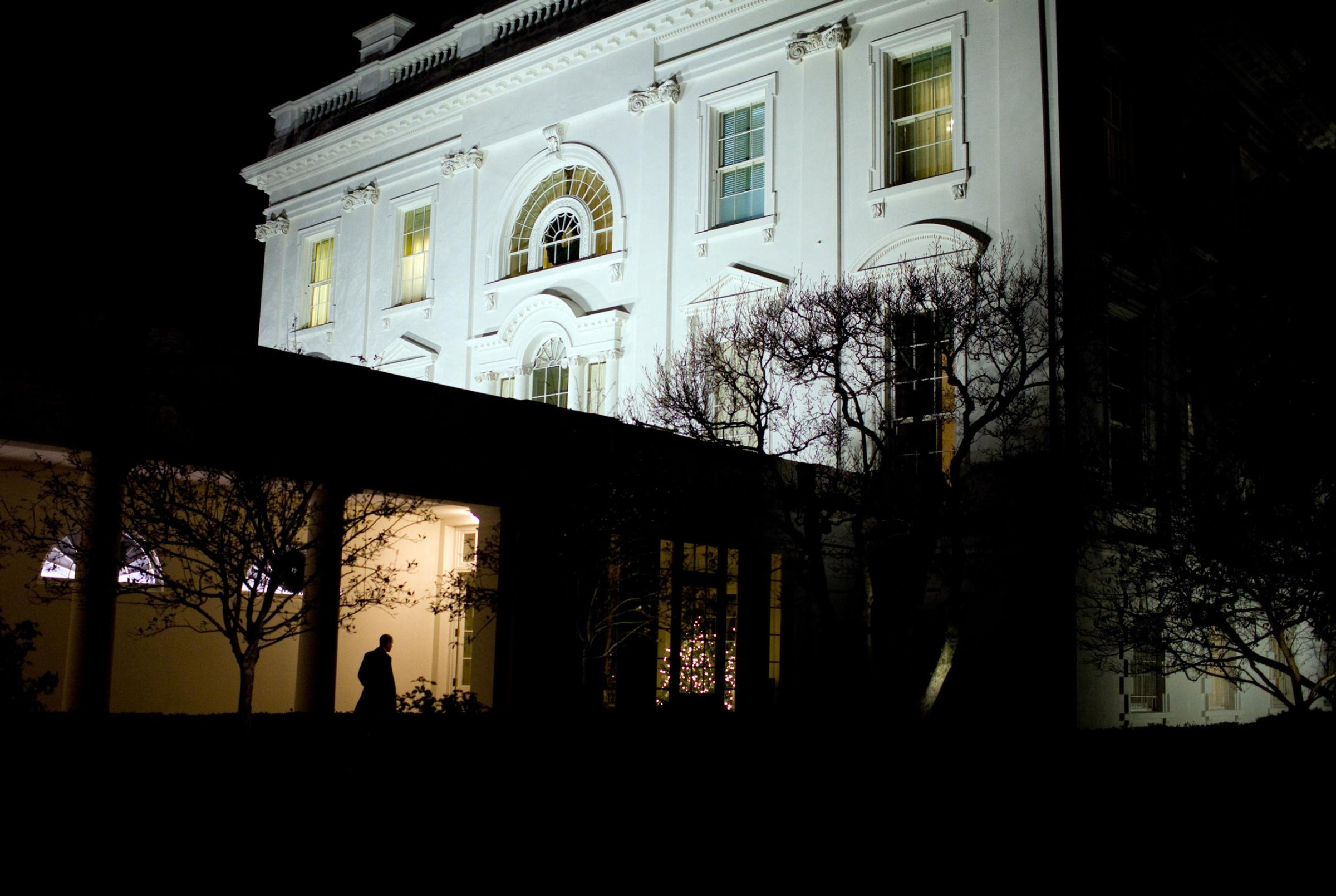 “President Obama heads along the White House colonnade to the residence after leaving the Oval Office for the day," Dec. 3, 2009.