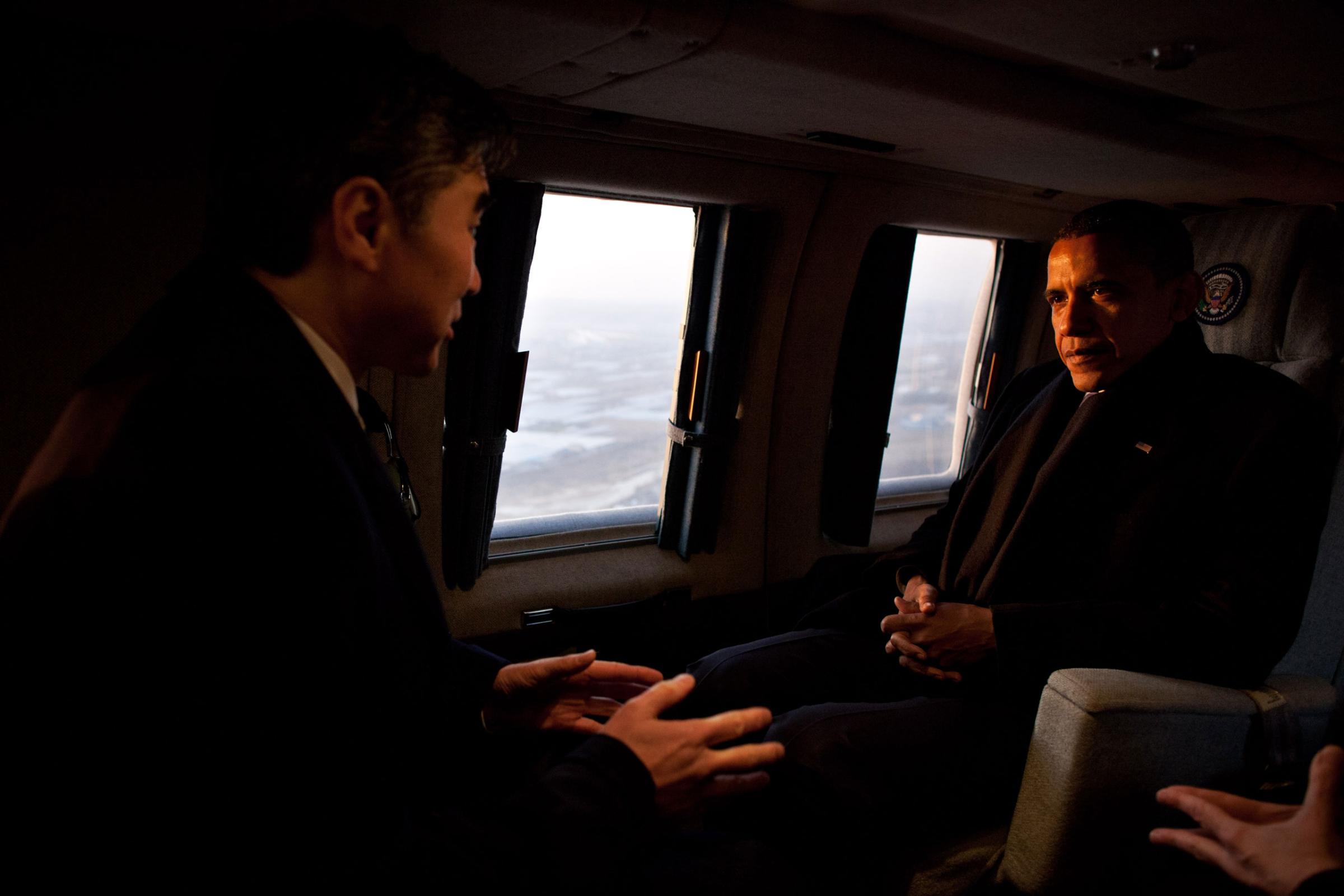 President Barack Obama talks with Sung Kim, U.S. Ambassador to Republic of Korea, aboard Marine One during an early morning flight from Osan Air Base to the landing zone at U.S. Army Garrison Yongsan in Seoul, Republic of Korea, March 25, 2012.
