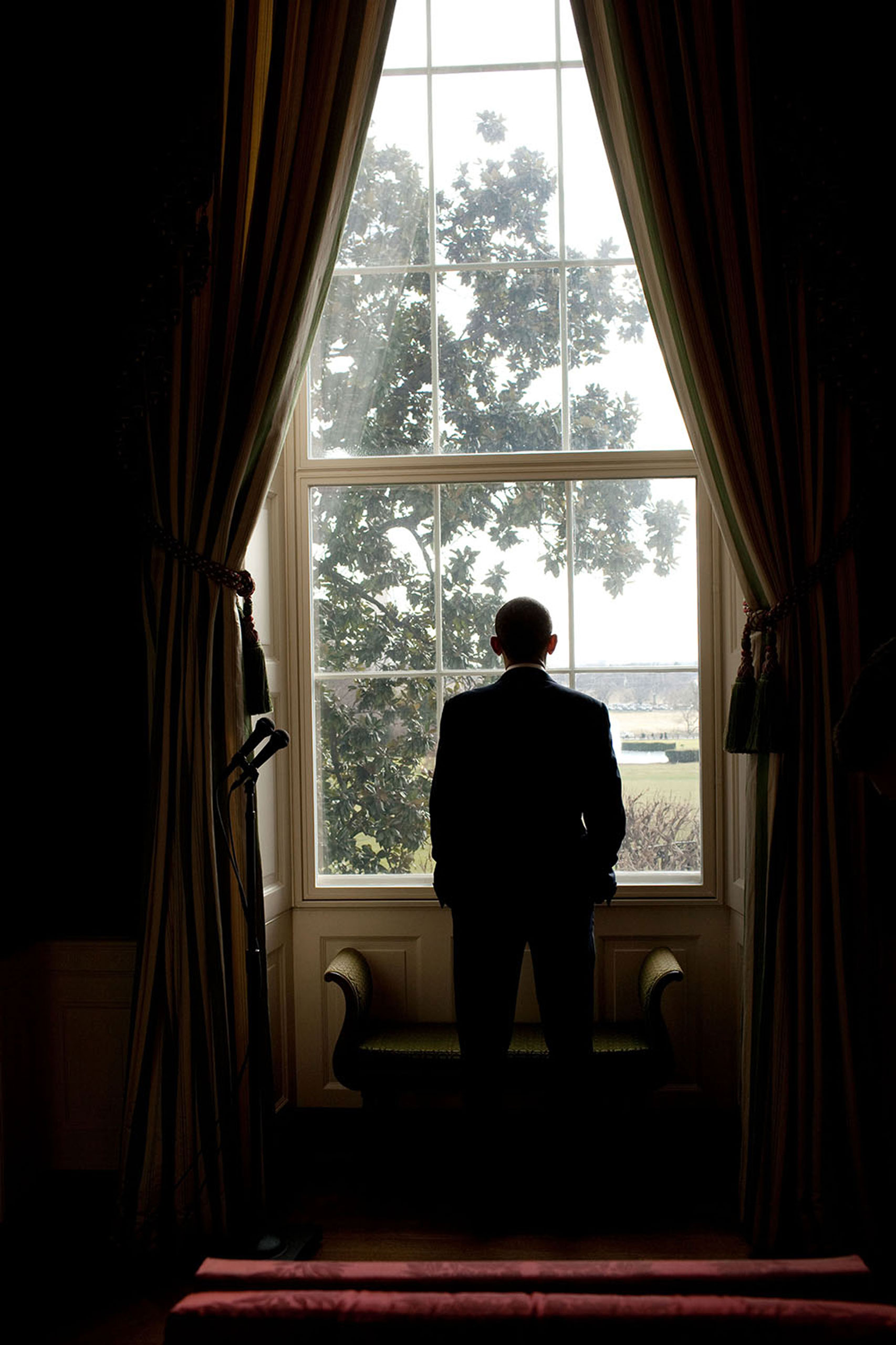 “While waiting to be introduced for an event in the East Room of the White House, the President looks out a window in the Green Room towards a view of the Washington Monument and Jefferson Memorial,”Jan. 6, 2010.
