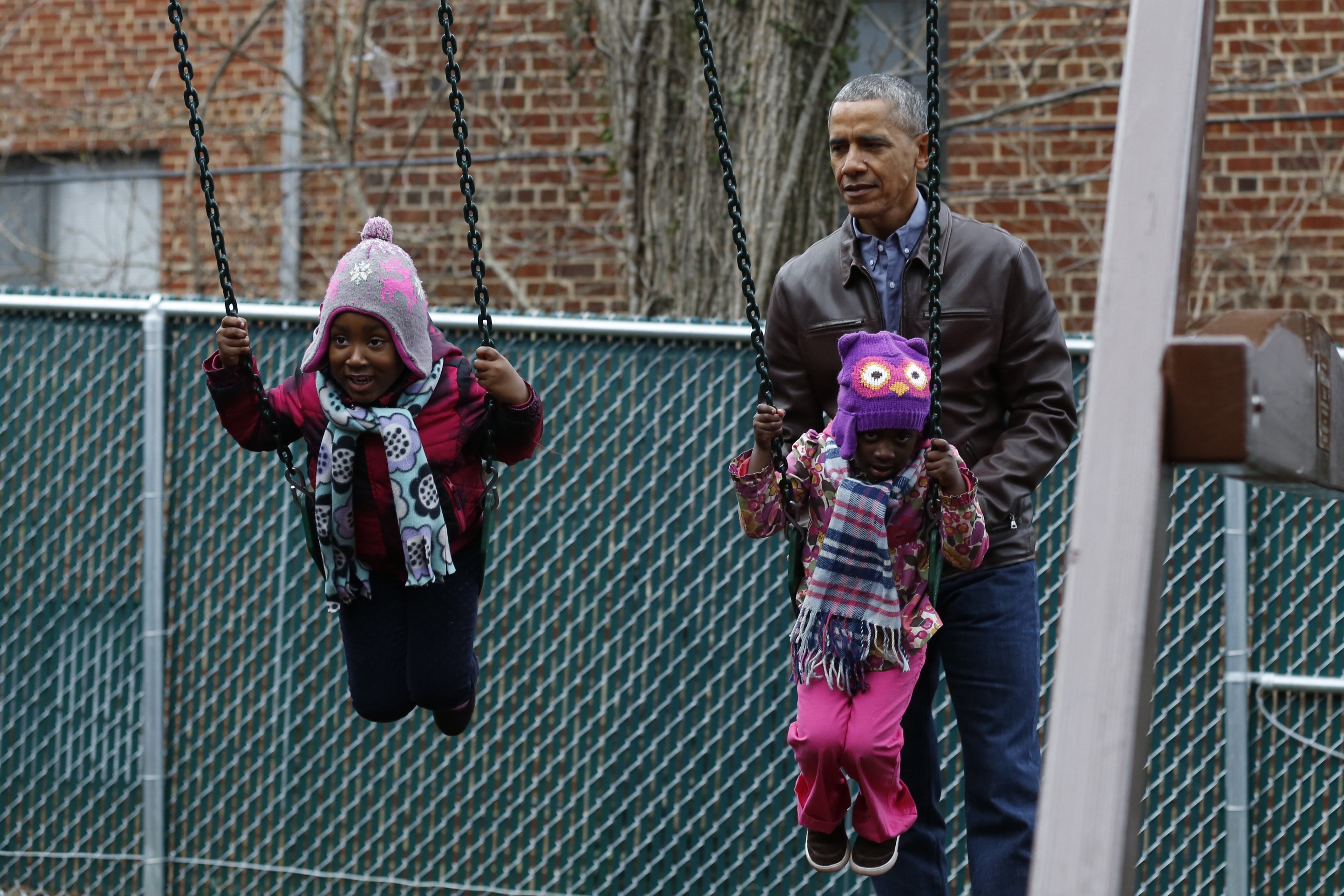 TOPSHOT - US President Barack Obama plays with children on a swing donated by the first family at the Jobs Have Priority Shelter in Washington, DC on January 16, 2017.  / AFP / YURI GRIPAS        (Photo credit should read YURI GRIPAS/AFP/Getty Images) (YURI GRIPAS—AFP/Getty Images)