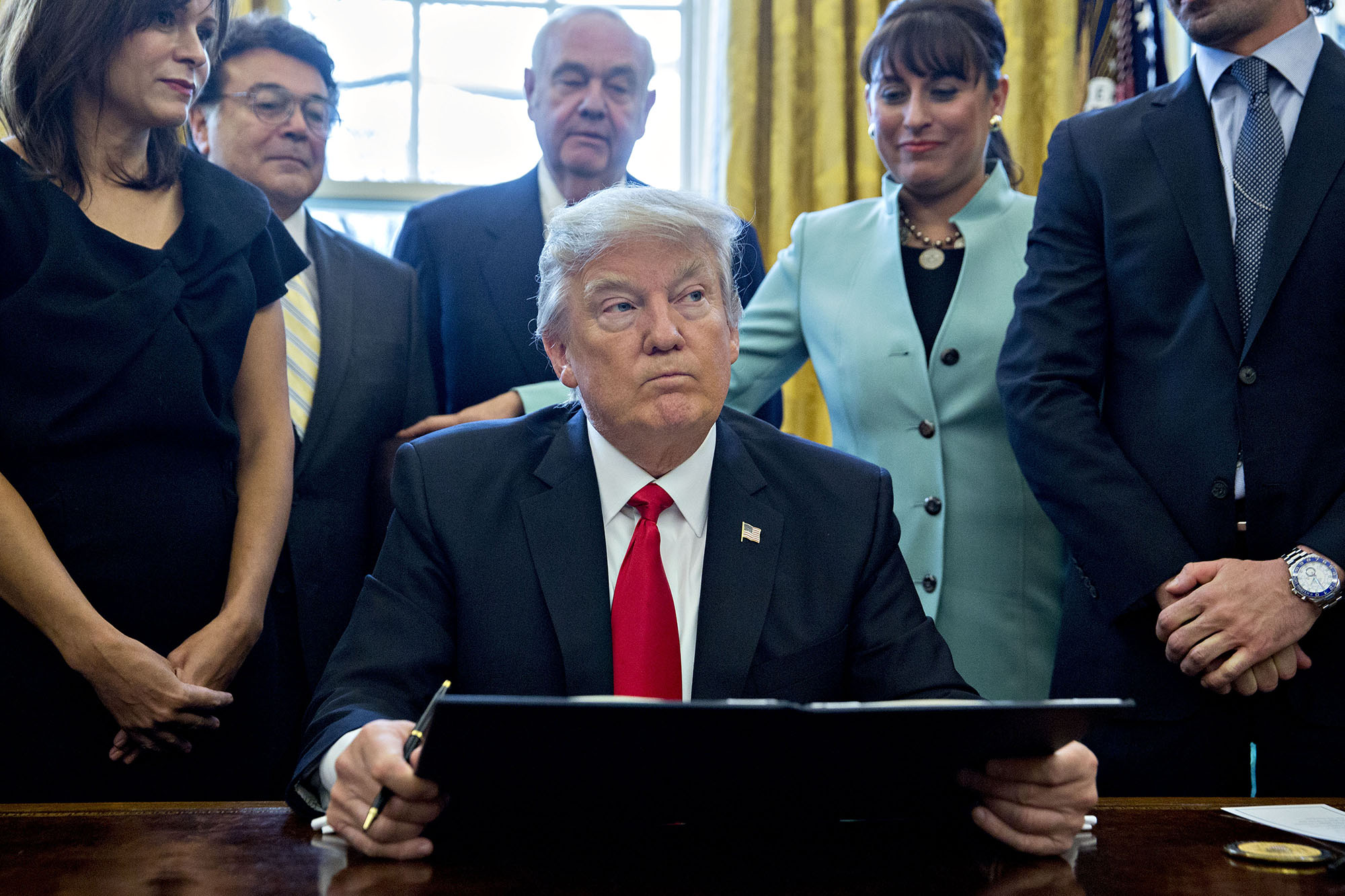 U.S. President Donald Trump pauses after signing an executive order. (Photographer: Andrew Harrer/Bloomberg via Getty Images) (Bloomberg&mdash;Bloomberg via Getty Images)