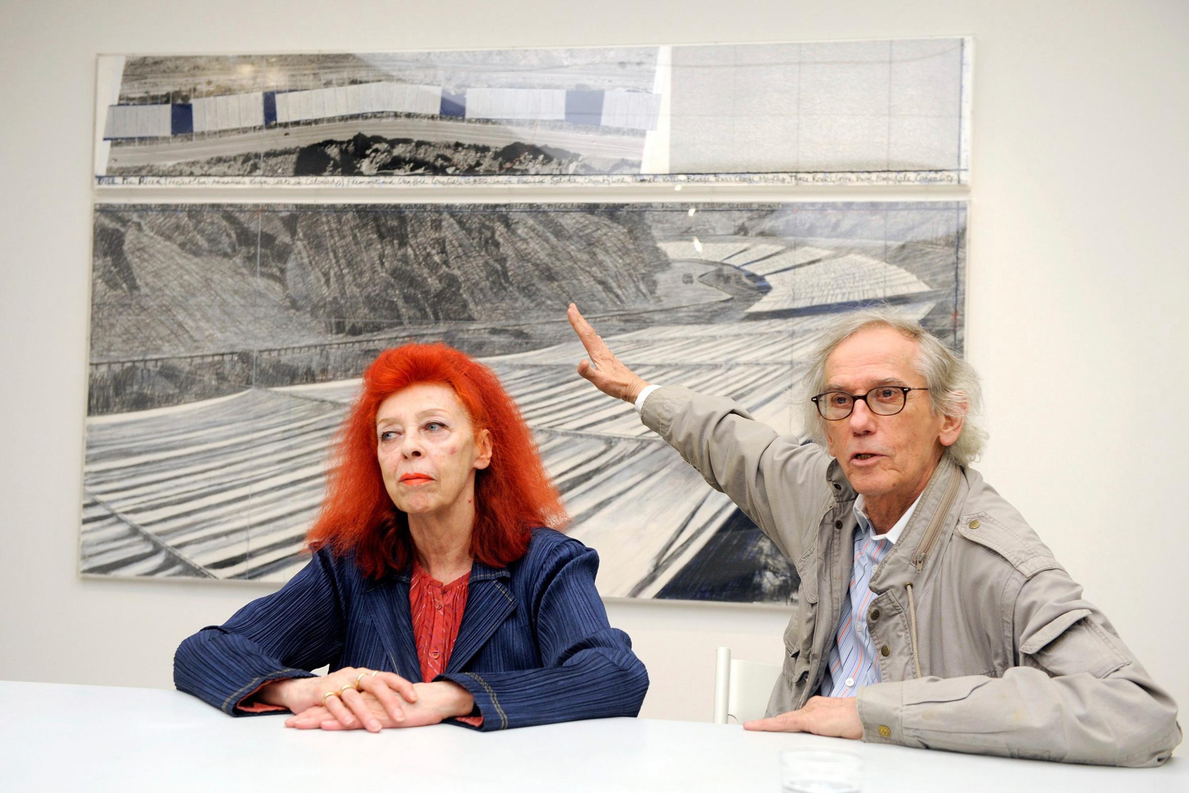 FILE--In this Feb. 11, 2009, file photograph, artist Christo, right, and his partner, Jeanne-Claude, are shown during a press conference for their exhibition "Over the River, A Work in Progress" at the Fondation de lHermitage in Lausanne, Switzerland. The artists' then-current artwork in progress was called, "Over The River," which proposed the horizontal suspension of fabric panels in separate segments along a stretch above the Arkansas River in southern Colorado. On Wednesday, Jan. 25, 2017, Christo announced that he has abandoned his plans for the display over the Arkansas River. (Keystone/Dominic Favre via AP, file)