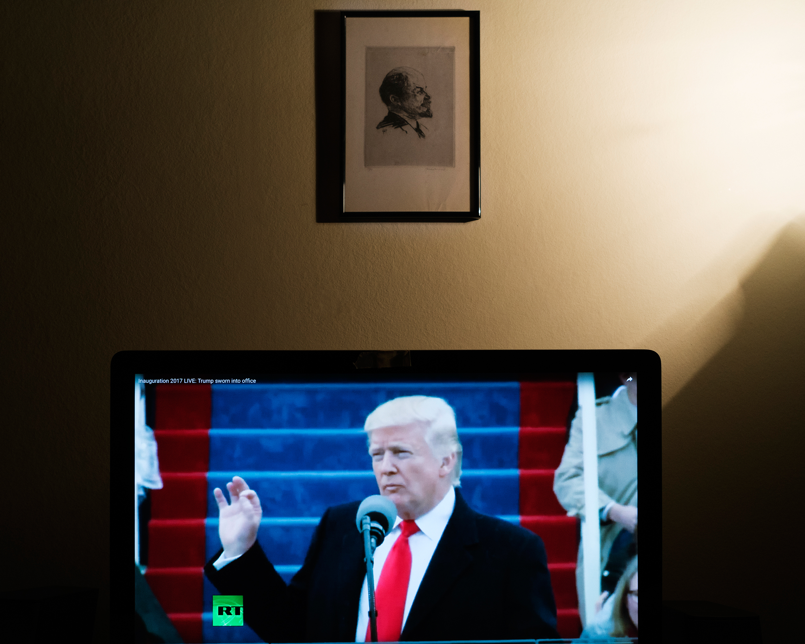 Donald Trump delivers his first address as the 45th American president in a broadcast carried by Russian state television network RT on Jan. 20, 2017. A portrait of Vladimir Lenin hangs on the wall of the photographer's home.