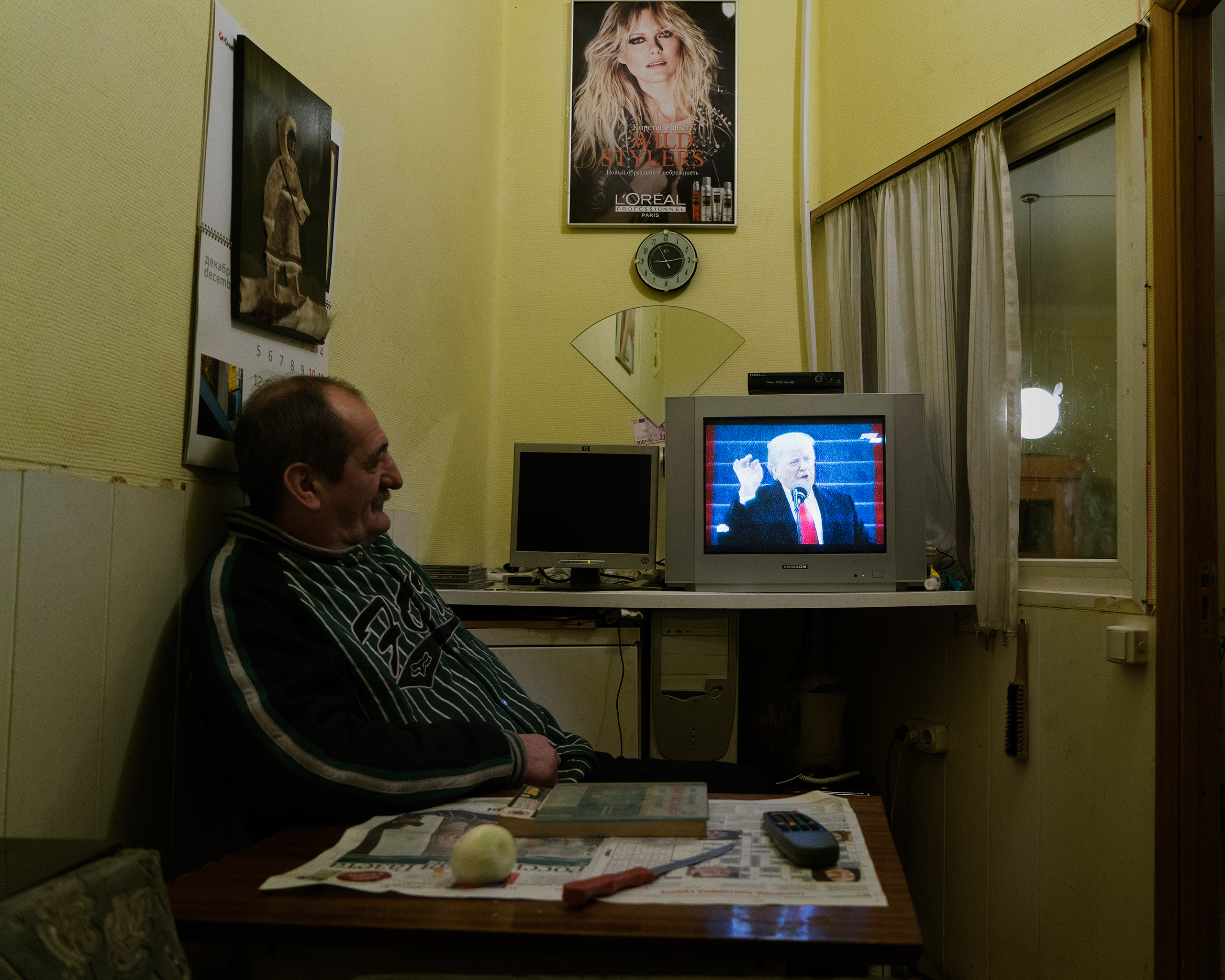A man watches U.S. President Donald Trump deliver his first address on his Inauguration Day in Moscow on Jan. 20, 2017.