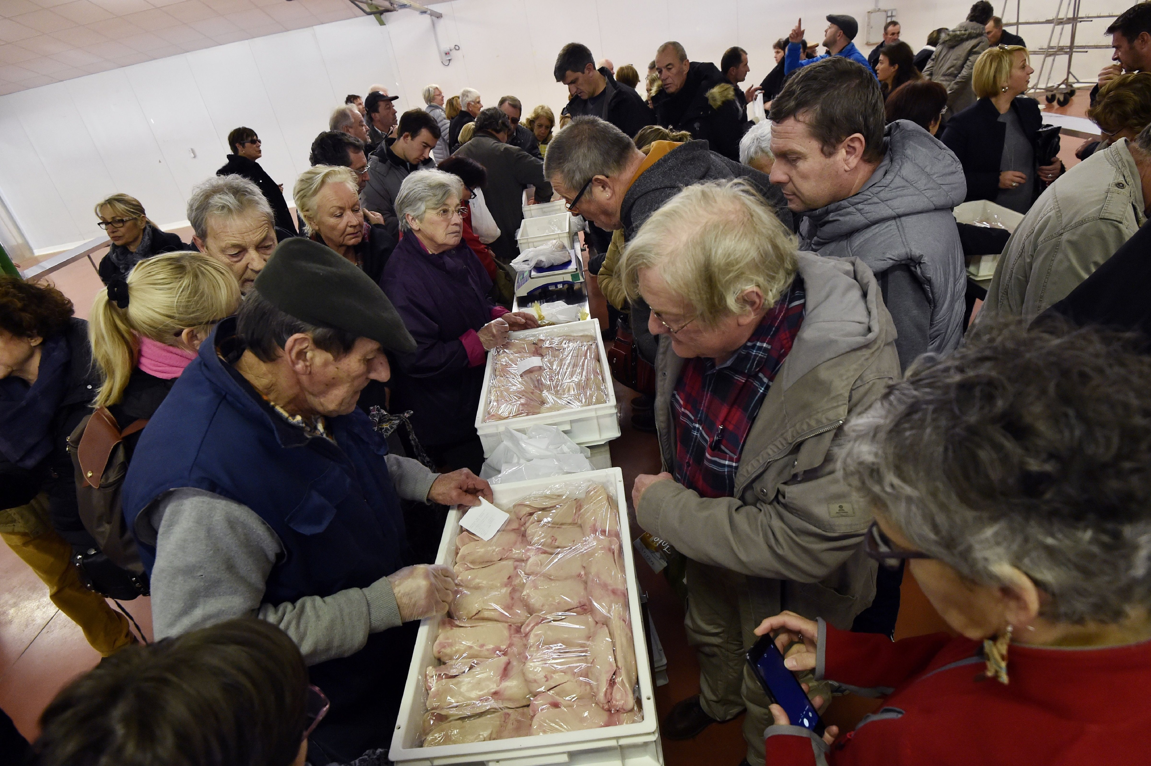 People buy foie groie in the market in Samatan, southwestern France on Dec. 5, 2016. An outbreak of avian influenza H5N8, "highly pathogenic" for birds but "harmless to humans", was detected in a duck farm in the Tarn commune of Almayrac, announced on Dec. 2, 2016 the Ministry of Agriculture. (Pascal Pavani—AFP/Getty Images)