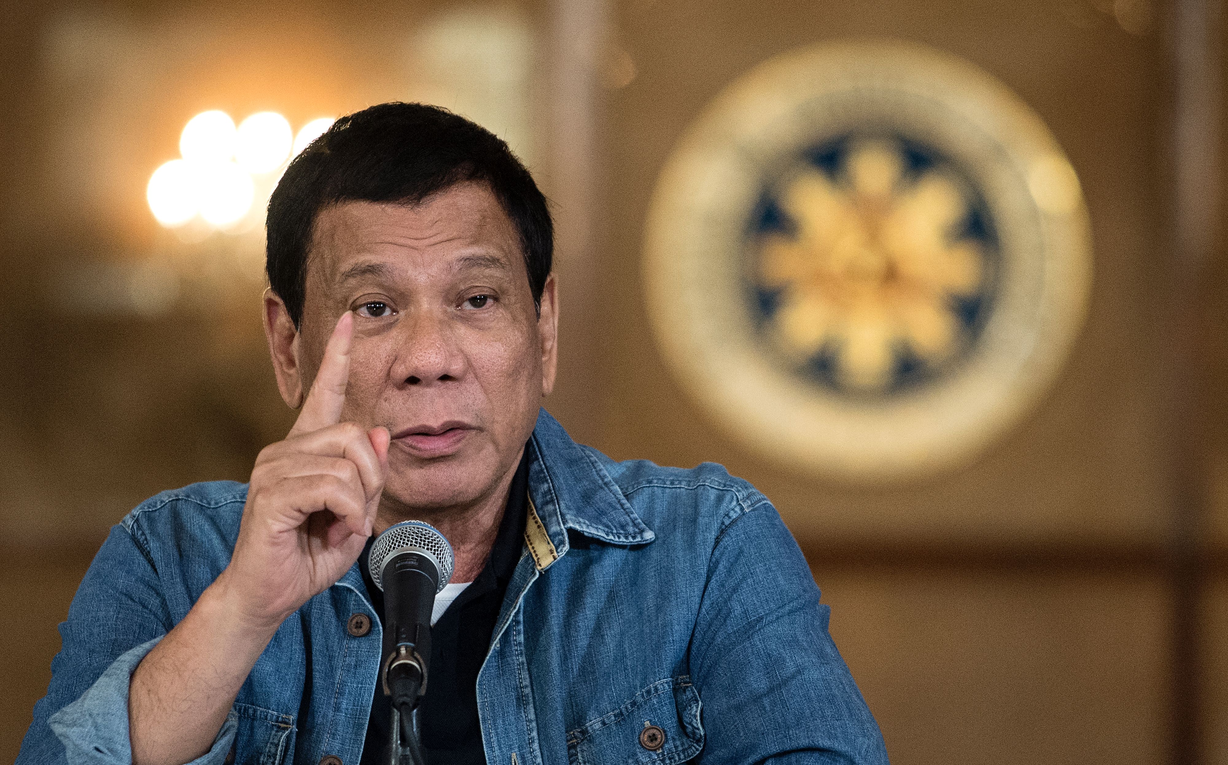 Philippine's President Rodrigo Duterte gestures as he answers a question during a press conference at the Malacanang palace in Manila on January 30, 2017.
