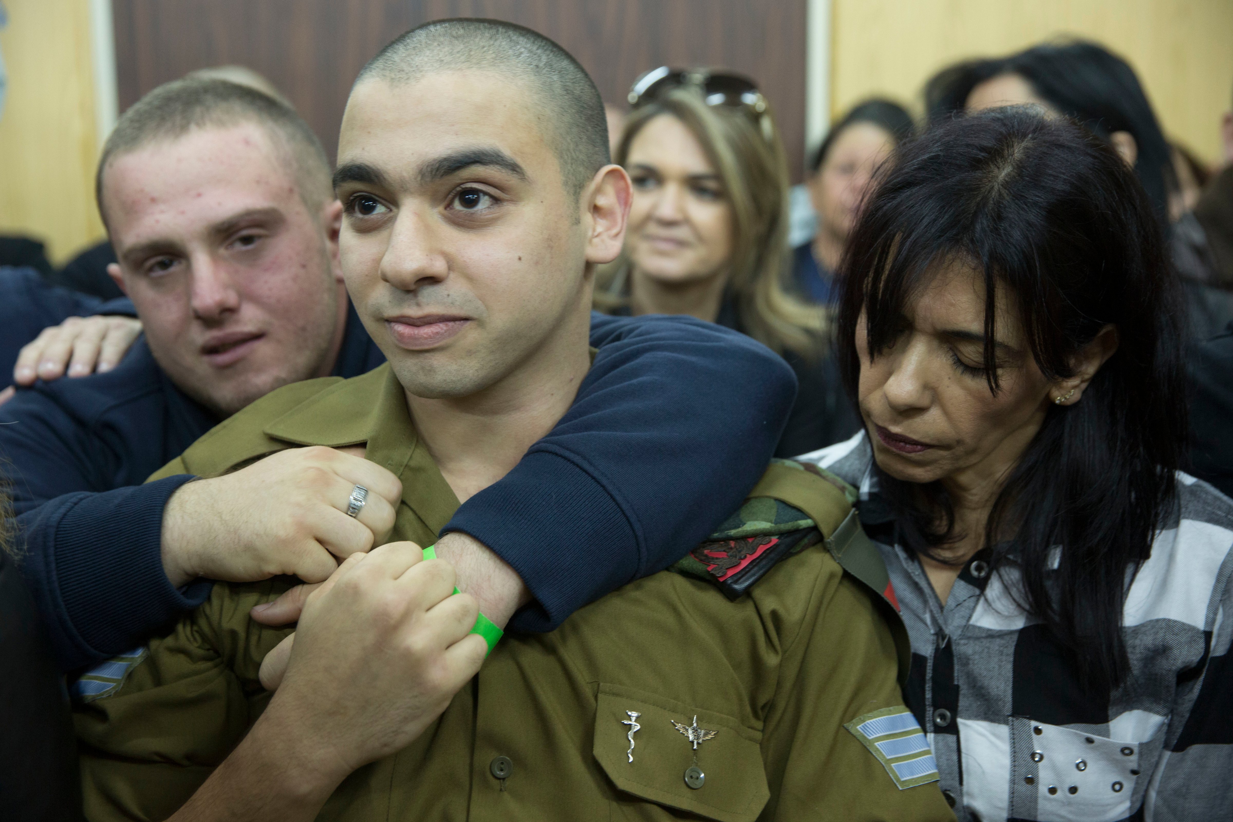 Elor Azaria waits with his parents for the verdict inside the military court in Tel Aviv, Israel, on Jan. 4, 2017. (Heidi Levine—AP)