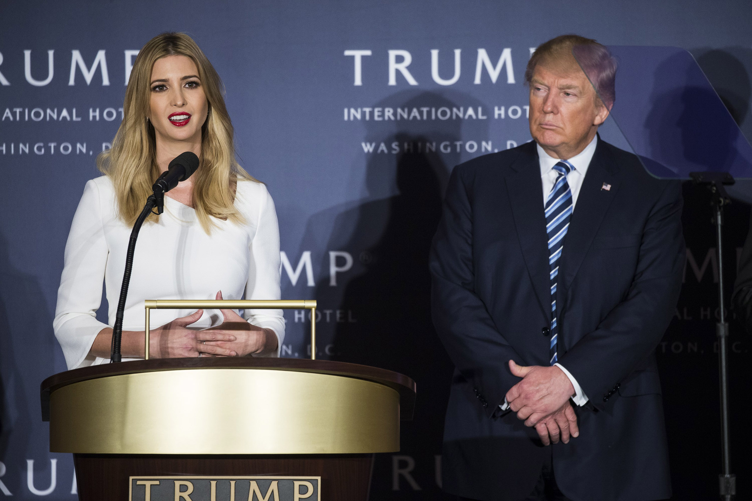 Ivanka Trump speaks as her father, Donald Trump, stands with her on stage during the opening ceremony for the Trump International Hotel, Old Post Office, in Washington on Oct. 26, 2016. (Samuel Corum—Anadolu Agency/Getty Images)