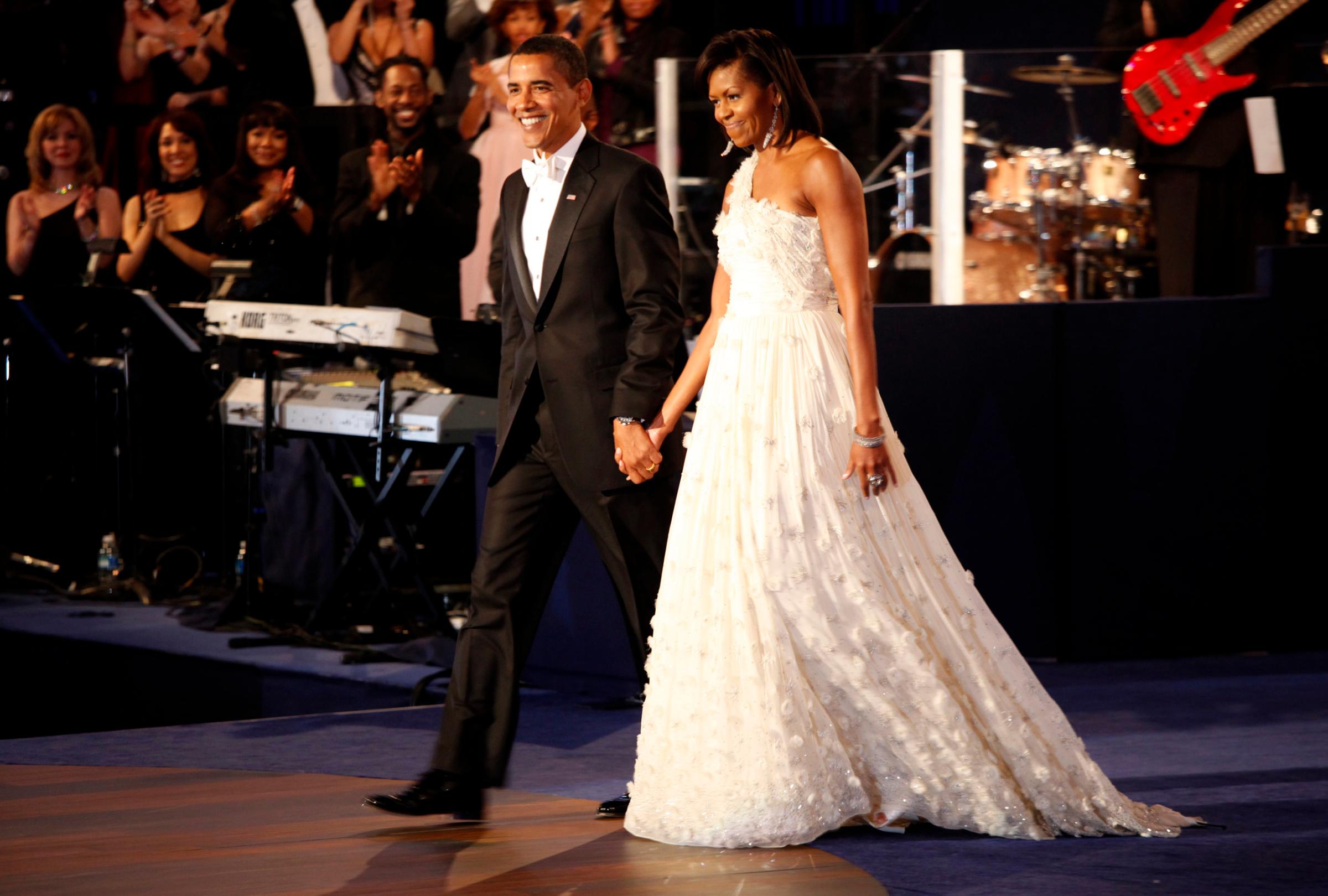 President Barack Obama and first lady Michelle arriving on stage for a dance, at the Neighborhood Inaugural Ball at the Convention Center in Washington, Tuesday, January 20, 2009.