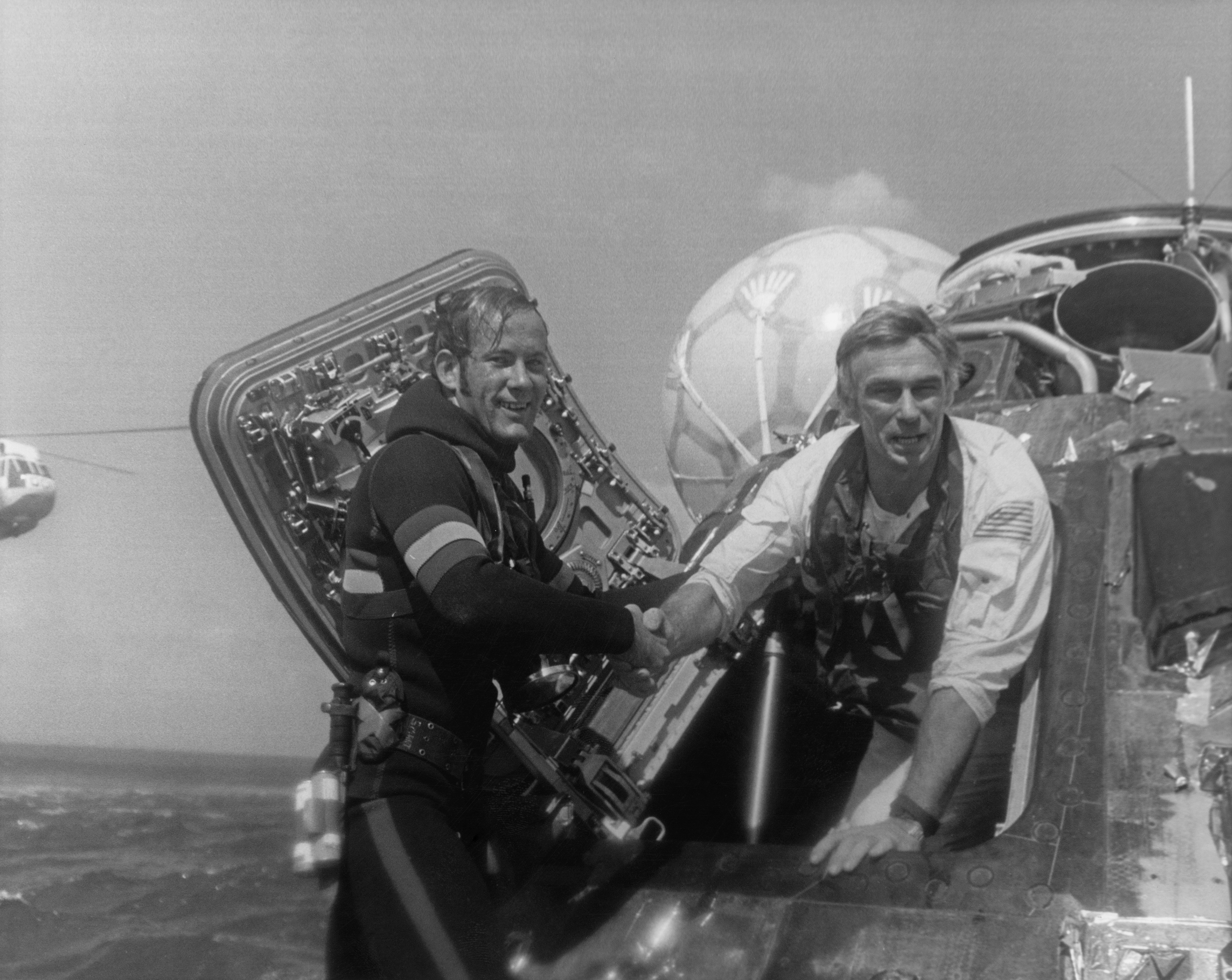 NASA astronaut Eugene Cernan, Commander of the Apollo 17 lunar mission, is welcomed back to Earth by a US Navy Pararescueman, after splashdown in the Pacific Ocean, 19th December 1972. (NASA&mdash;Getty Images)