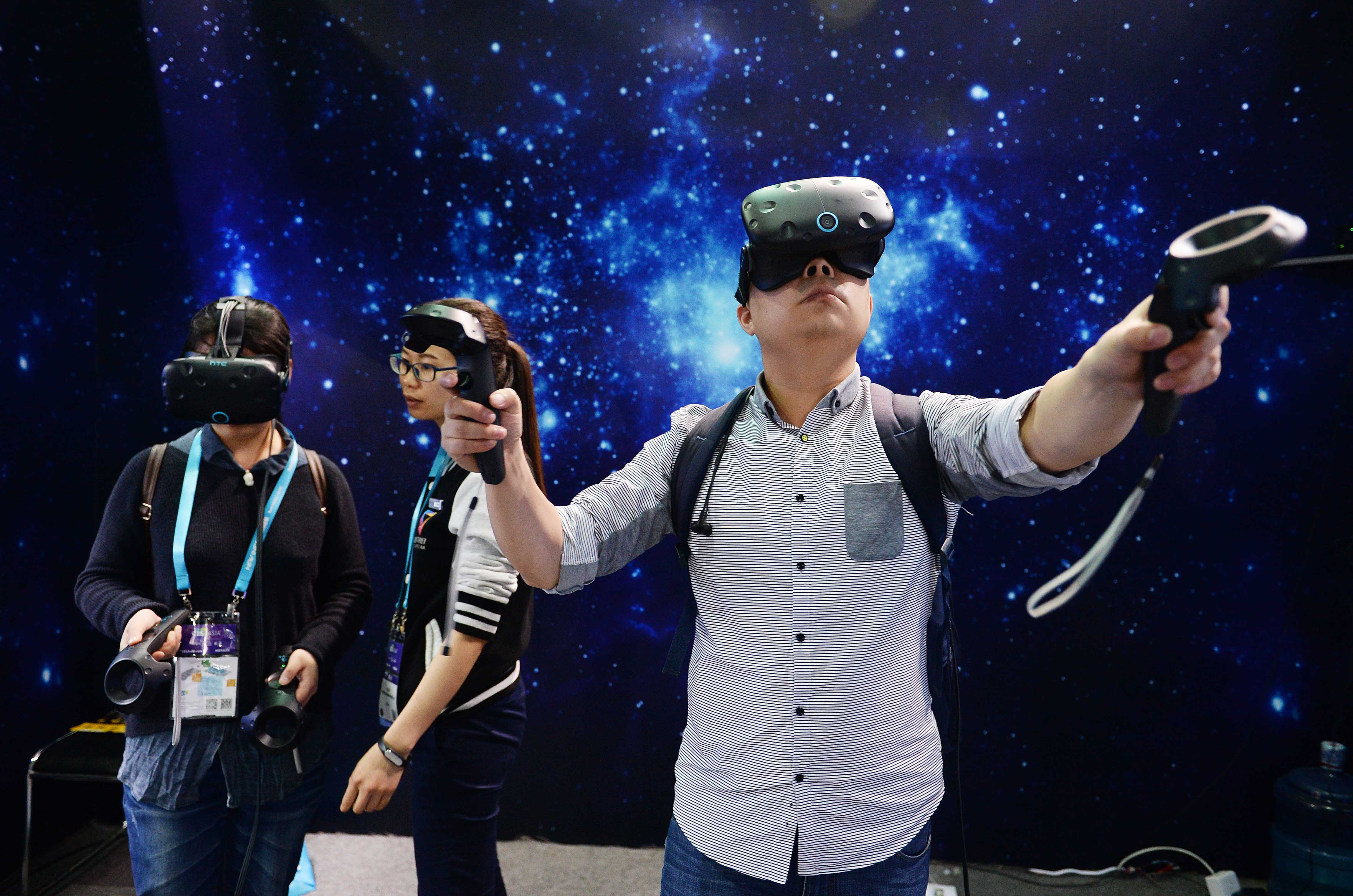 Visitors experience VR (virtual reality) devices during the CES Asia 2016 on May 11, 2016 in Shanghai, China. (VCG&mdash;VCG via Getty Images)