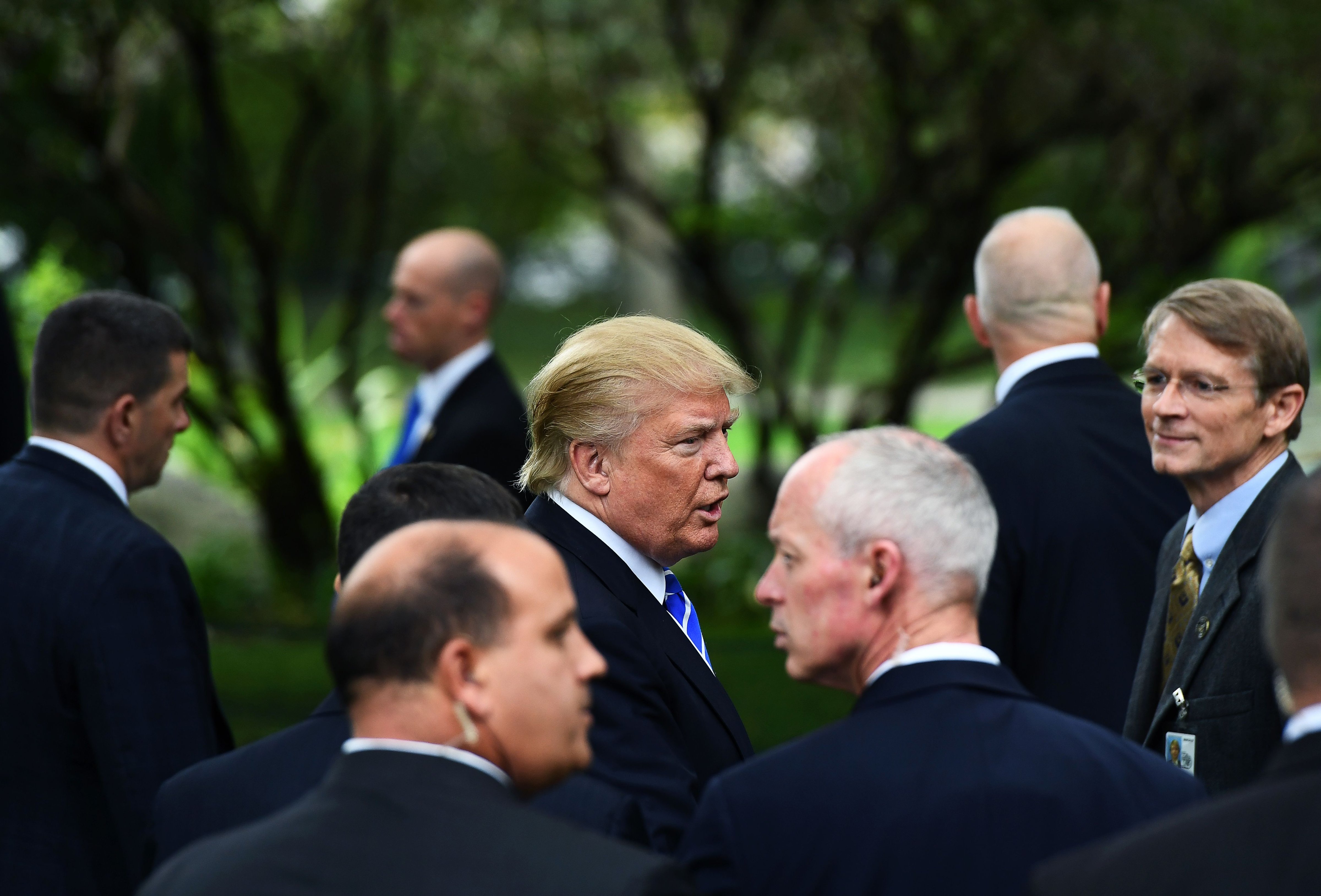 US Republican presidential nominee Donald Trump (C) is surrounded by members of the Secret Service as he visits the tomb of former US President Gerald Ford in Grand Rapids, Michigan, on September 30, 2016. (JEWEL SAMAD—AFP—Getty Images)