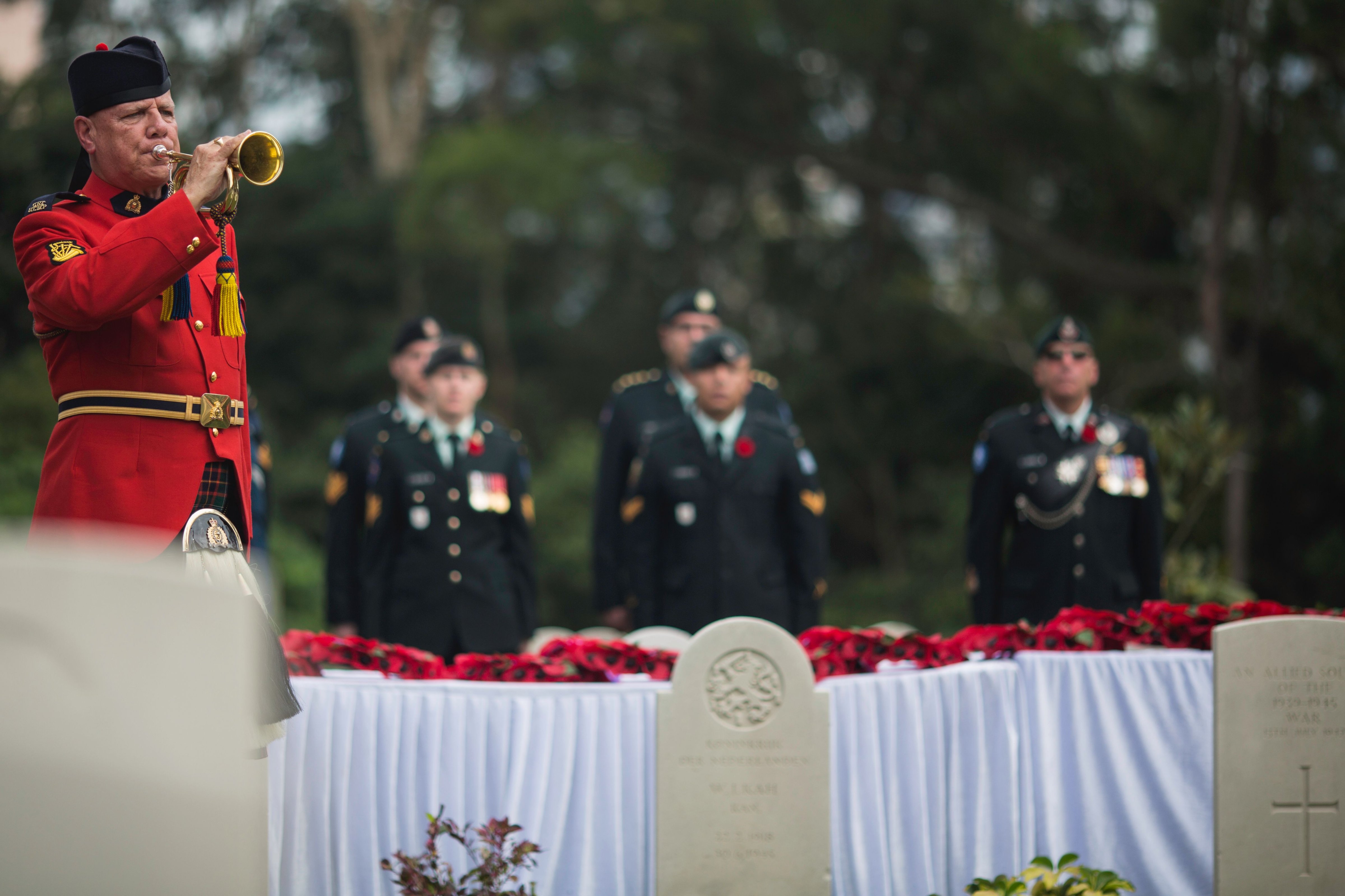 A bugler from the Royal Canadian Mounted Police plays the Last Post in Hong Kong's Sai Wan War Cemetery, on Dec. 4, 2016, during the Canadian commemorative ceremony honoring those who died during the Battle of Hong Kong and World War II (Tengku Bahar—AFP/Getty Images)